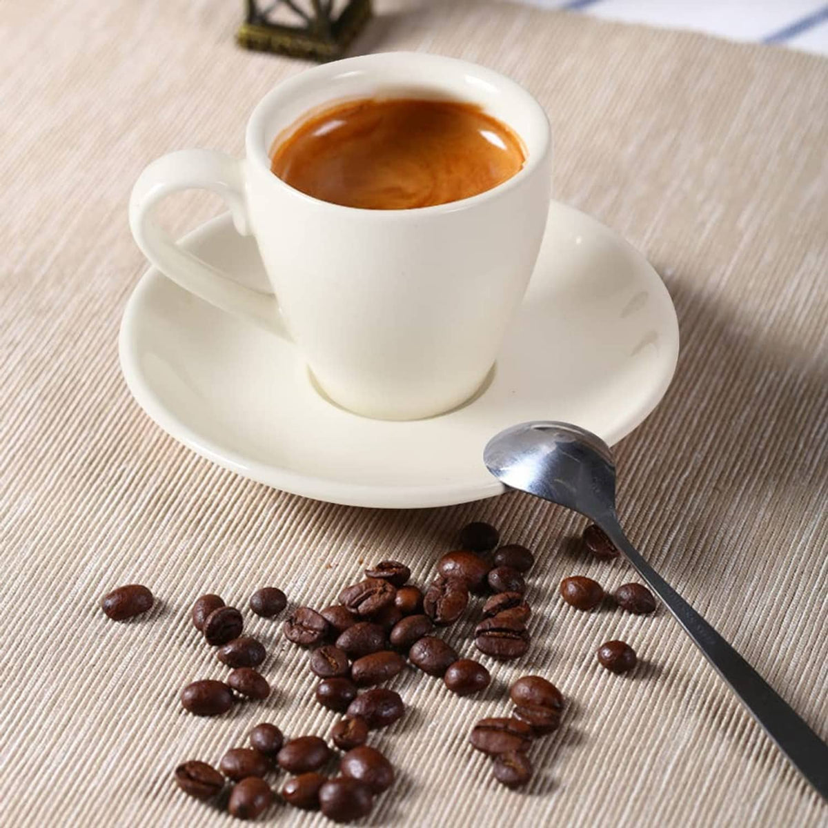 White porcelain espresso cup and saucer with espresso inside