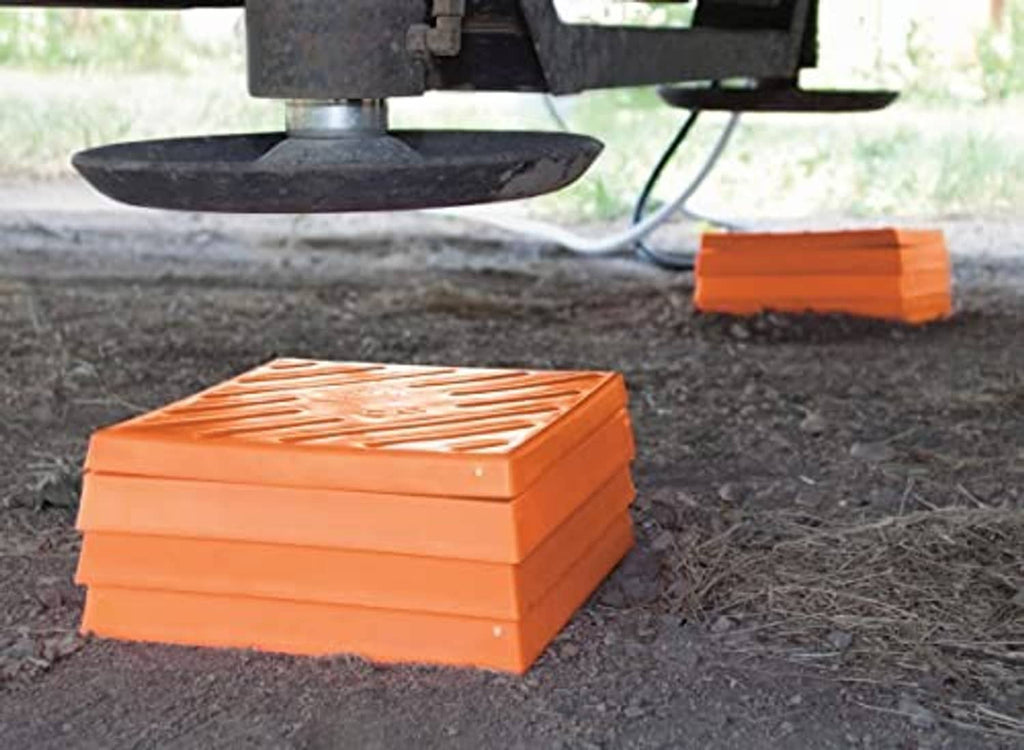 Orange plastic vehicle leveling blocks, stacked in a low profile package
