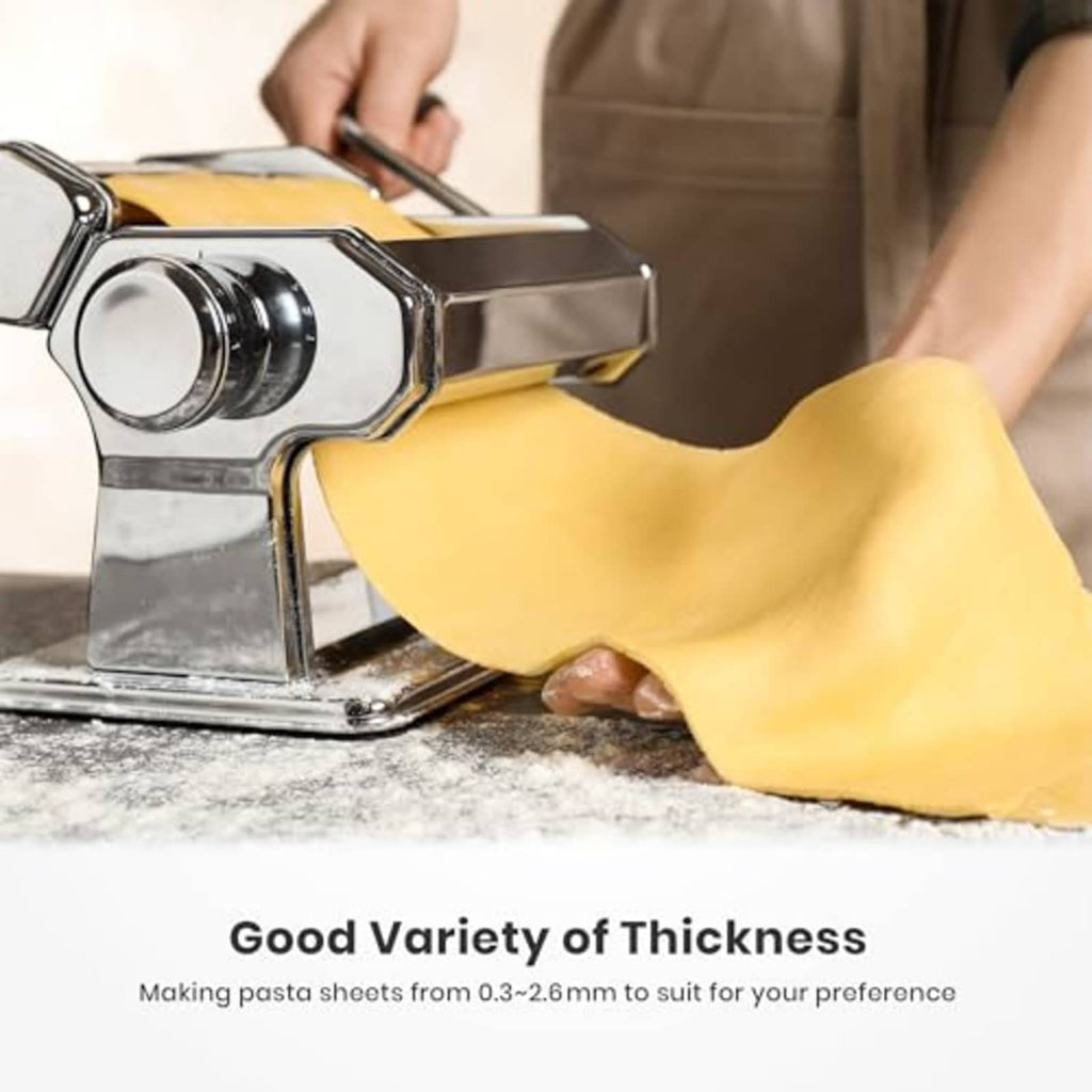 Pasta maker rolling a dough sheet into smooth pasta ribbons