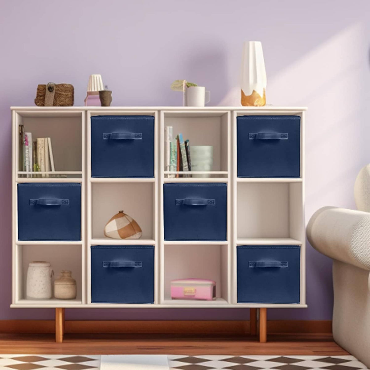 Dark blue fabric storage cube bins inside a cubby organizer, each with a handle