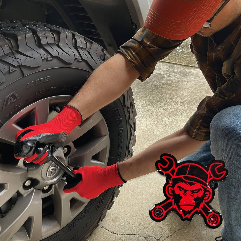 Orange and black nitrile-coated work gloves gripping a tire tool by a wheel