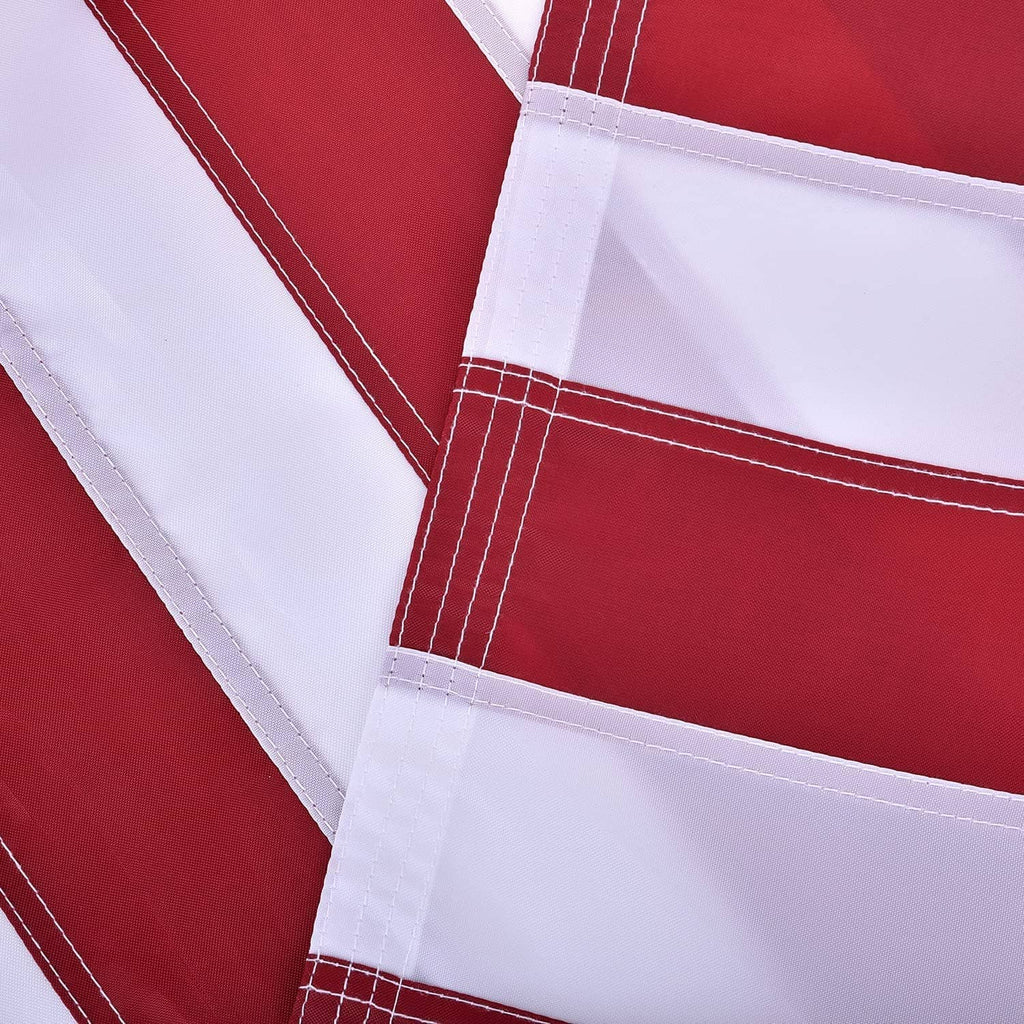 US flag stripes with stitched hem and white fabric border, layered close-up.