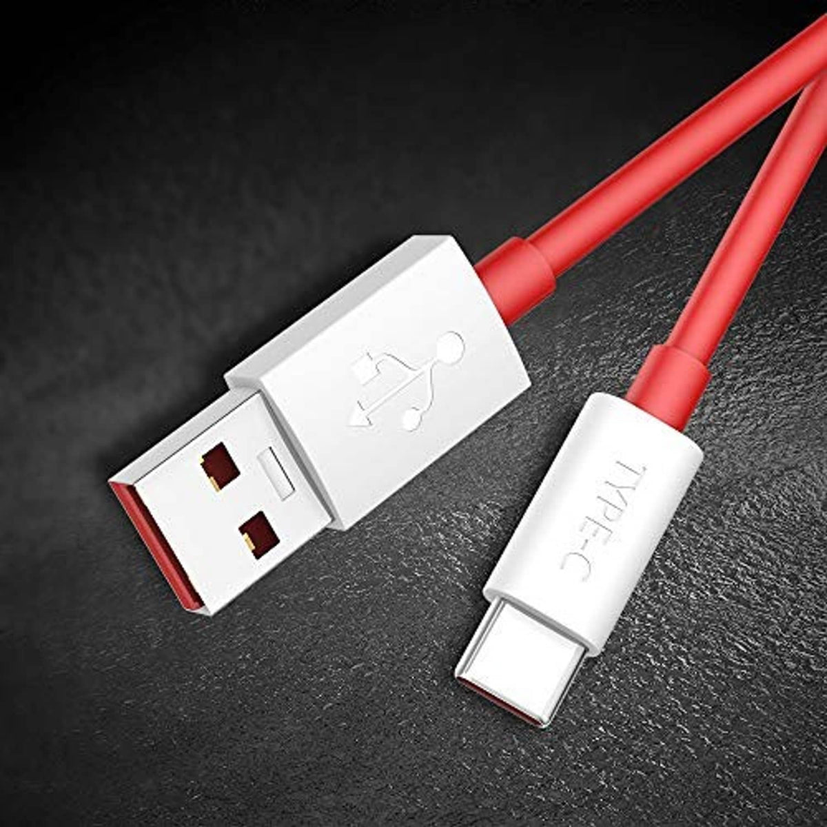 Red USB-C cable with USB-A plug and Type-C connector on dark surface