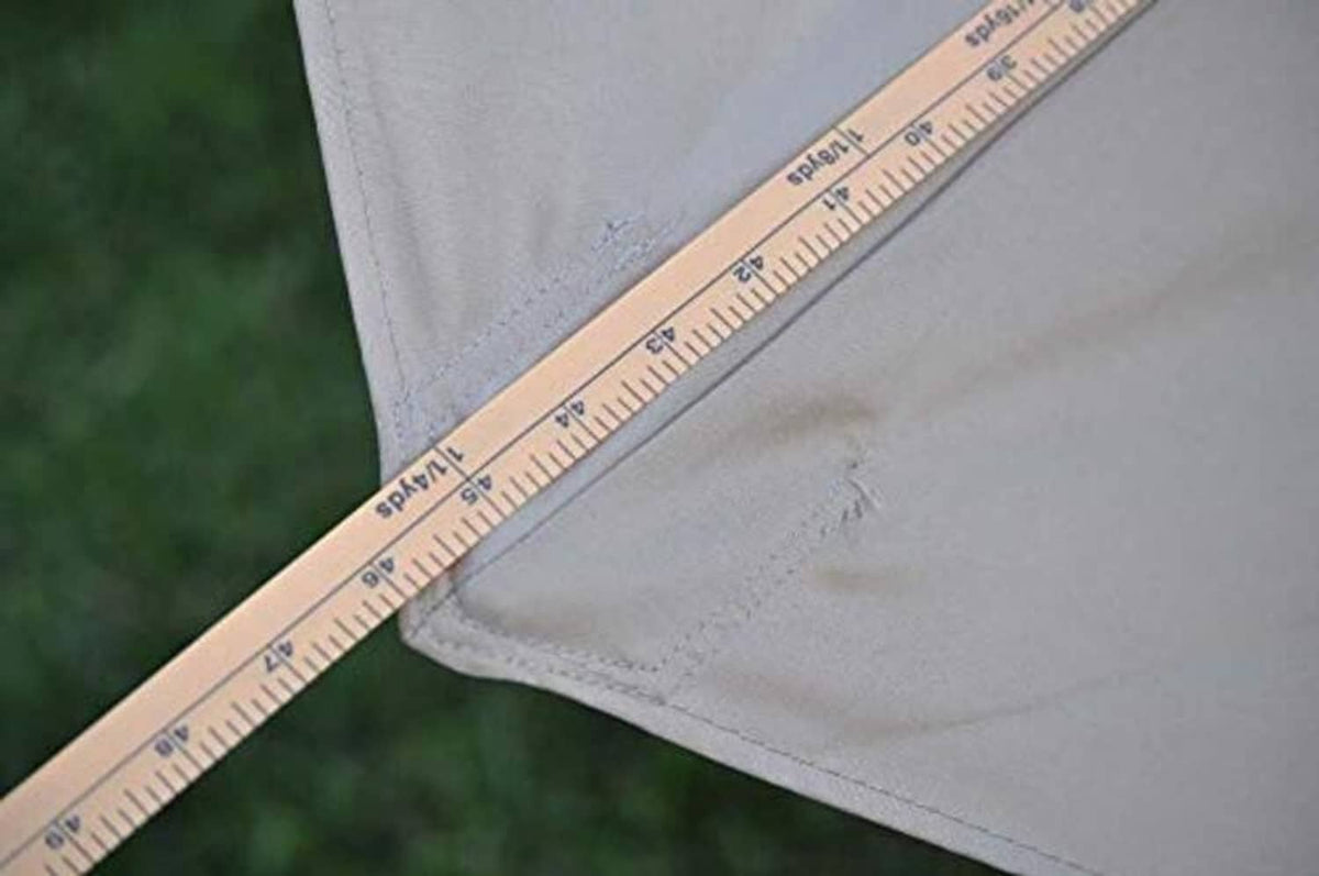 Gray canopy fabric corner with tape measure along the rib seam
