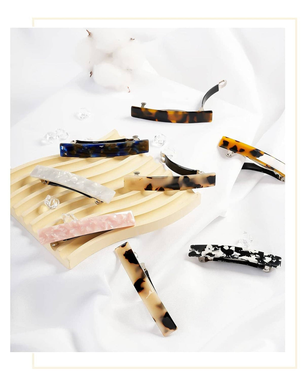 Assorted hair barrettes on a light background, featuring tortoiseshell, blue, pink, and clear.