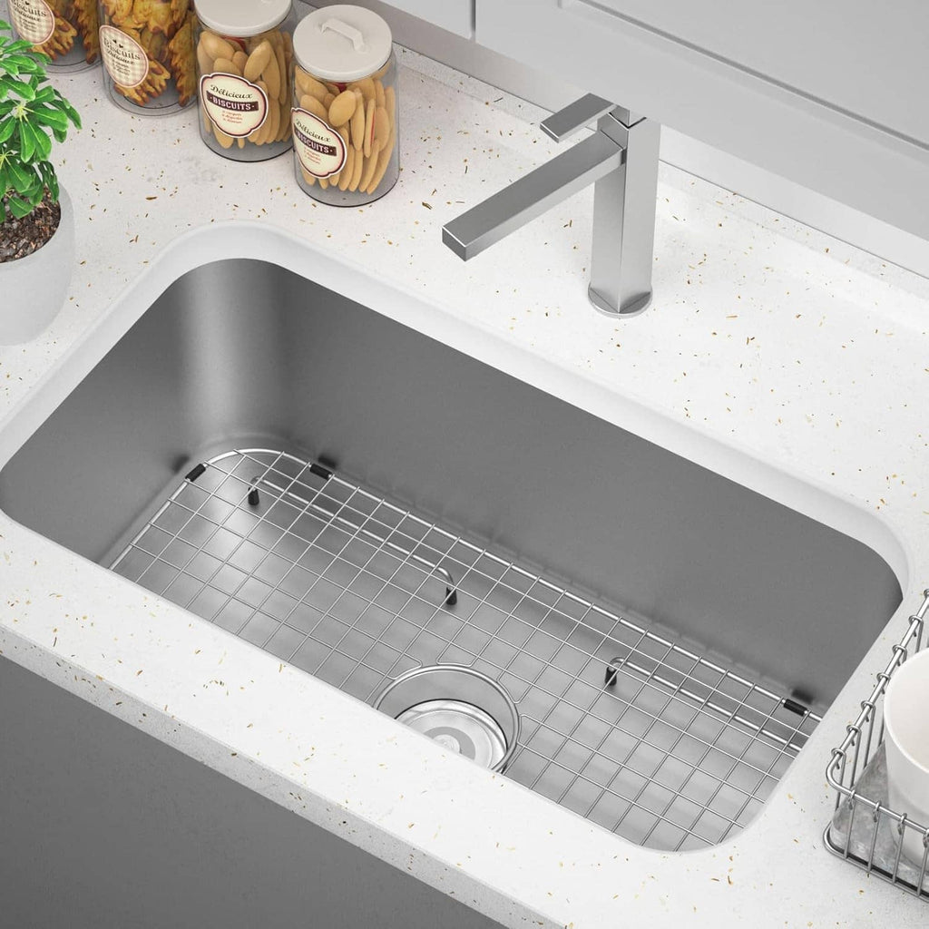Installed sink bottom grid in a rectangular stainless sink with circular drain hole