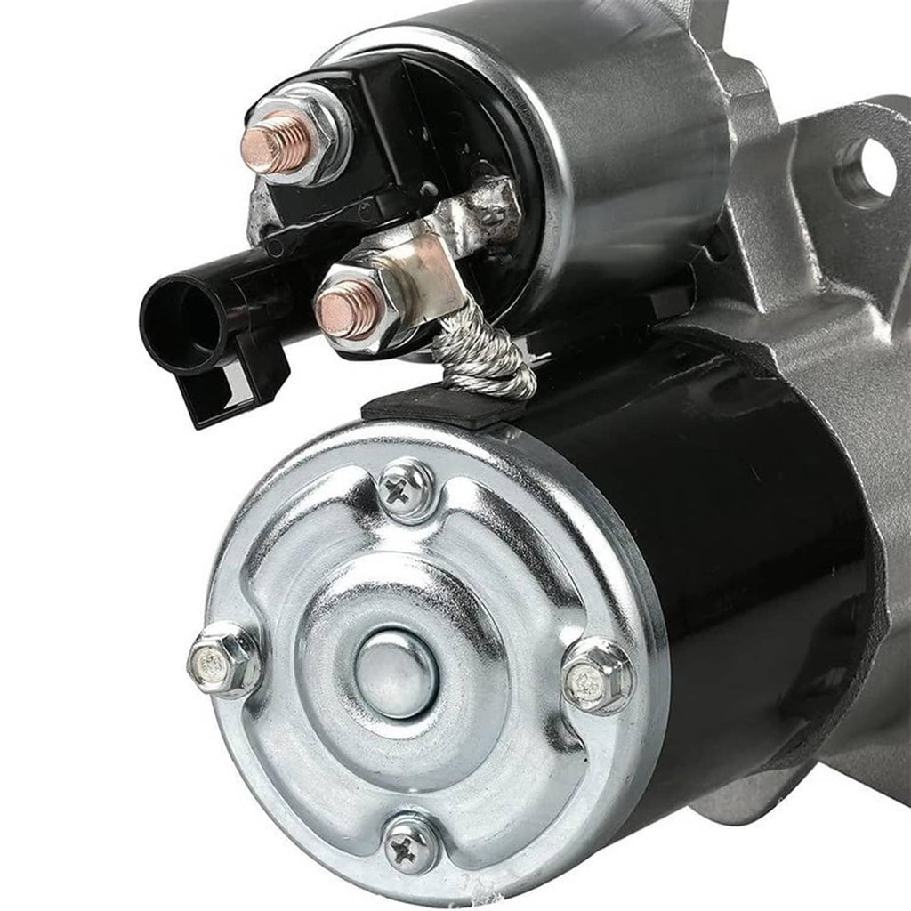 Starter motor with black solenoid cap, chrome mounting ring, and cable connections.
