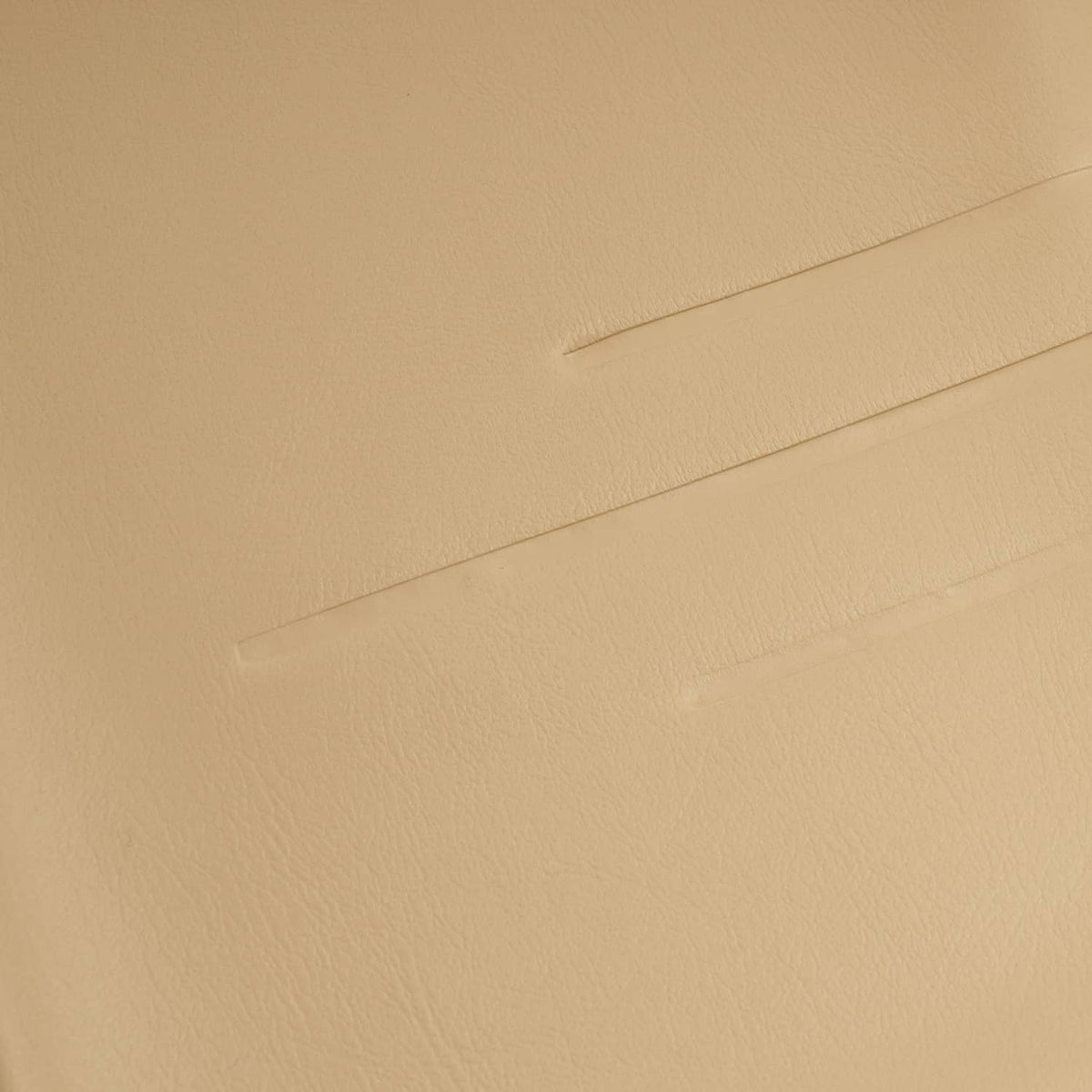 Tan seat back cover close-up, embossed seam and fine texture