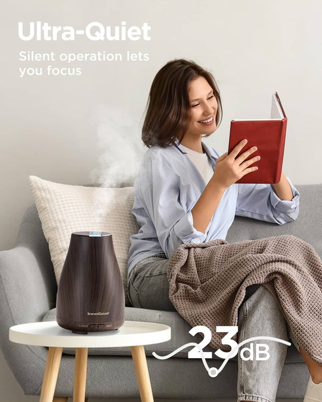 Brown ultrasonic essential oil diffuser with mist plume and LED lighting on countertop