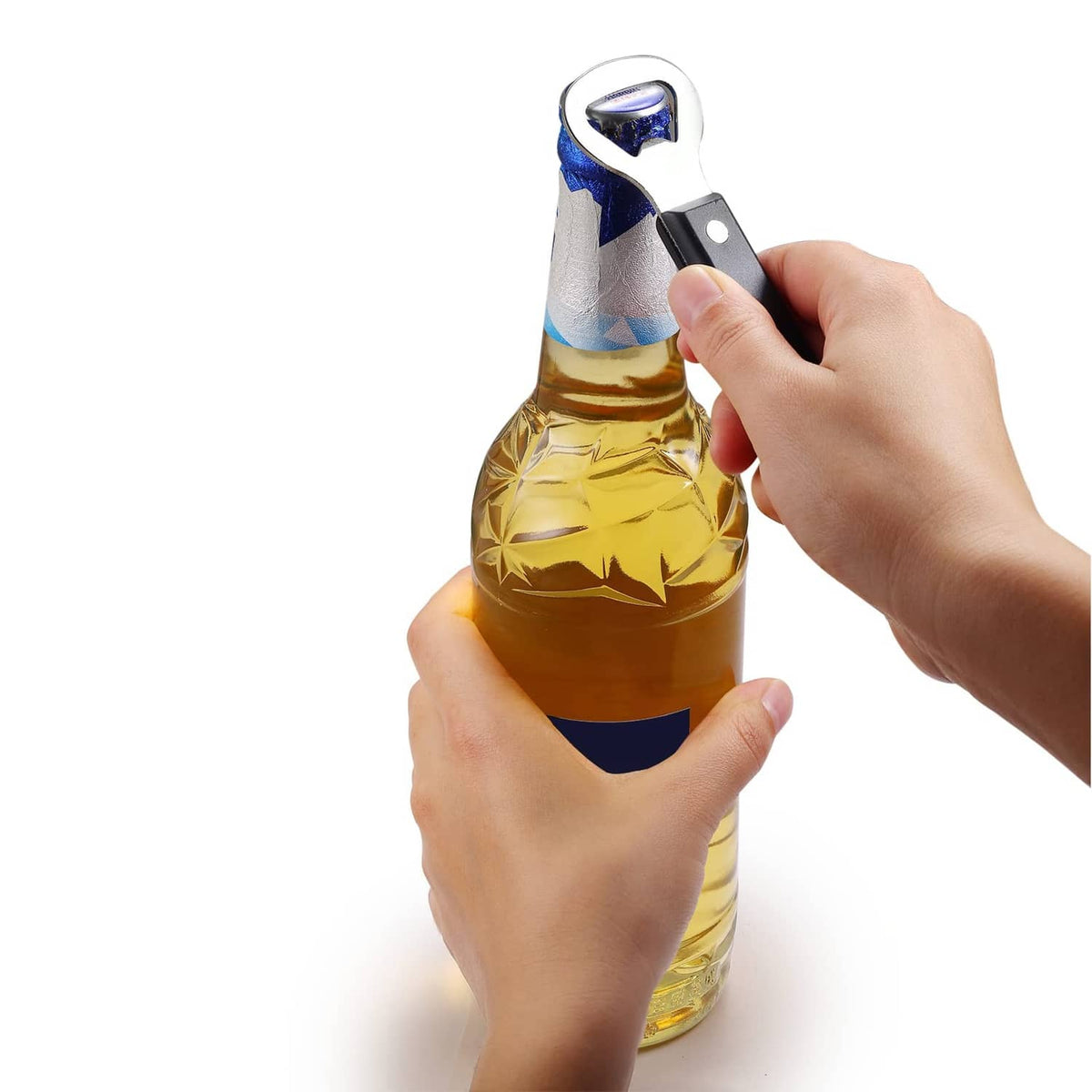 Manual can punch bottle opener in hand, punching a bottle cap from a glass bottle