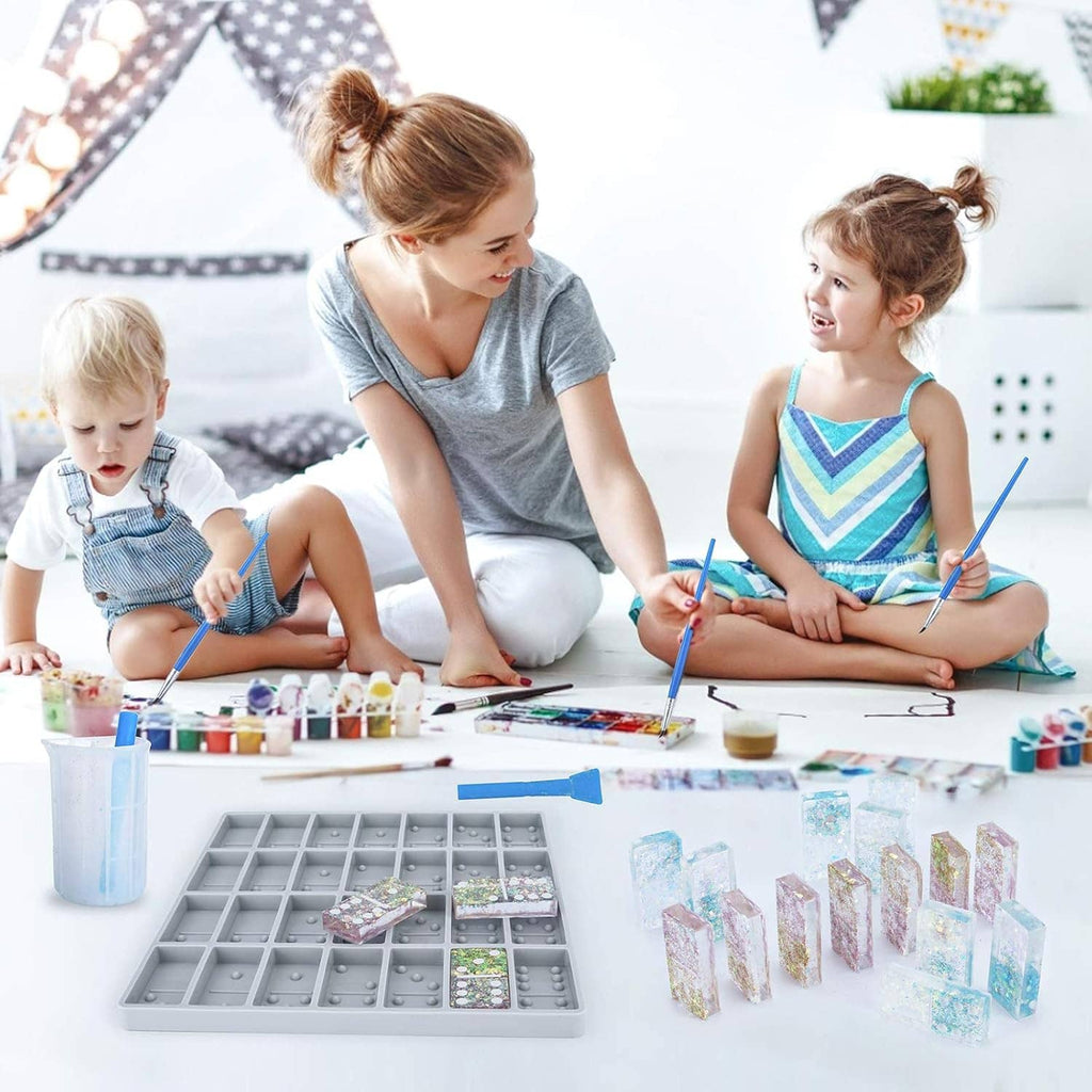 Jumbo resin domino silicone mold tray with finished glitter domino blocks on tabletop