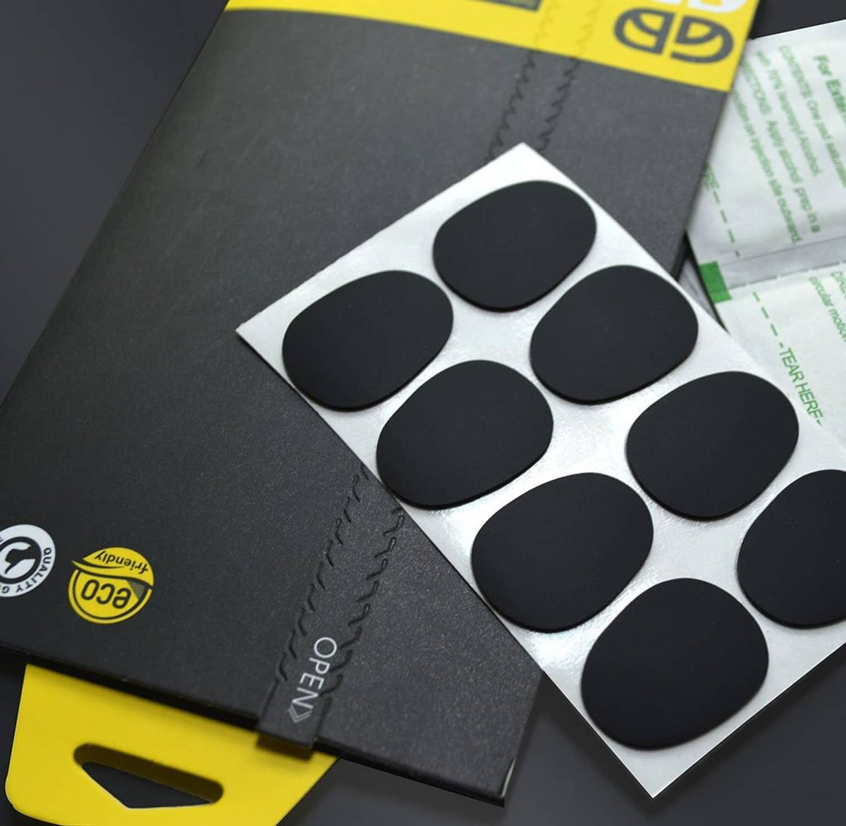 Close-up of black mouthpiece cushion pads on backing sheet