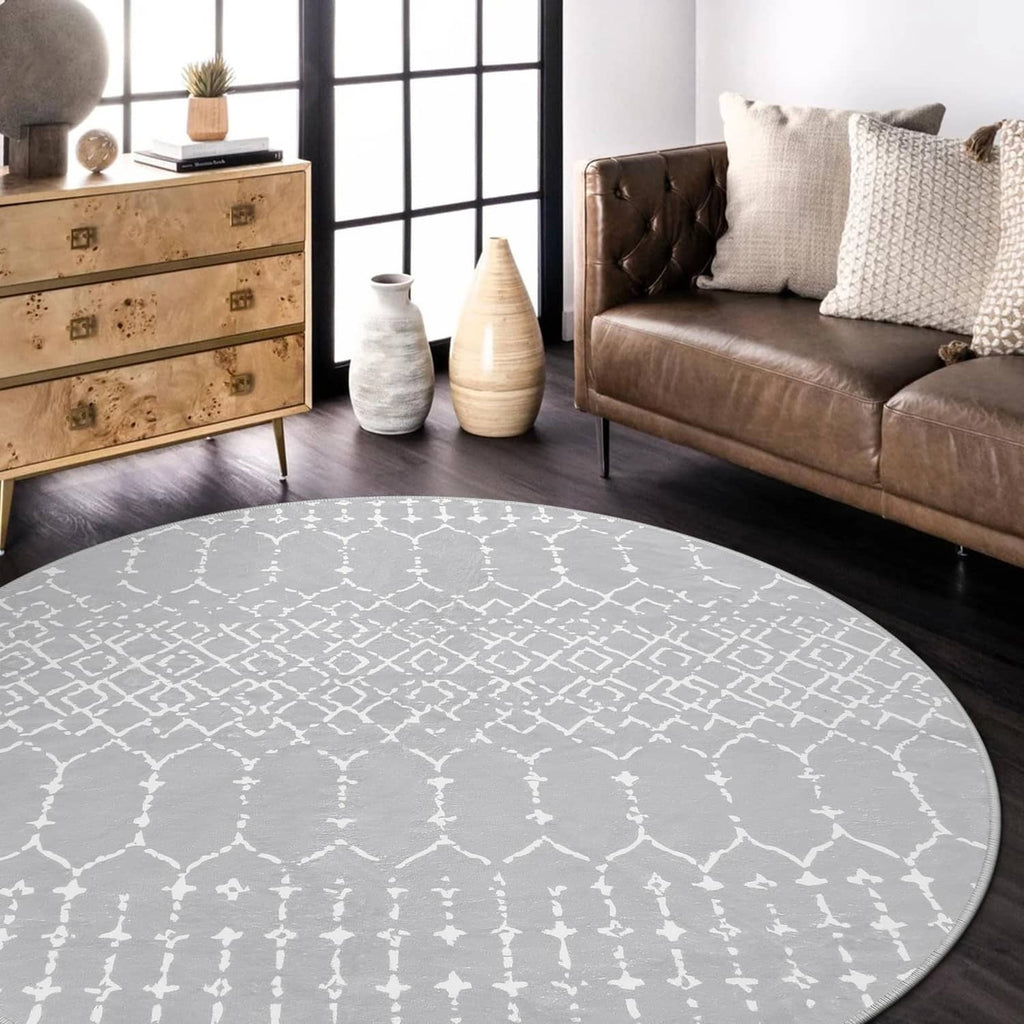 Grey round area rug with white Moroccan trellis motif, stitched round border, low pile