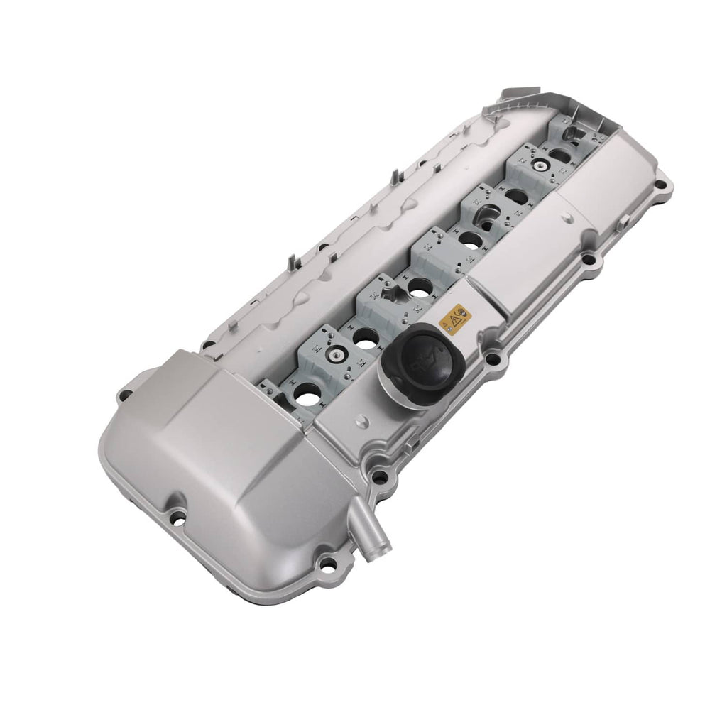 Light gray aluminum valve cover with black oil cap and integrated mounting tabs