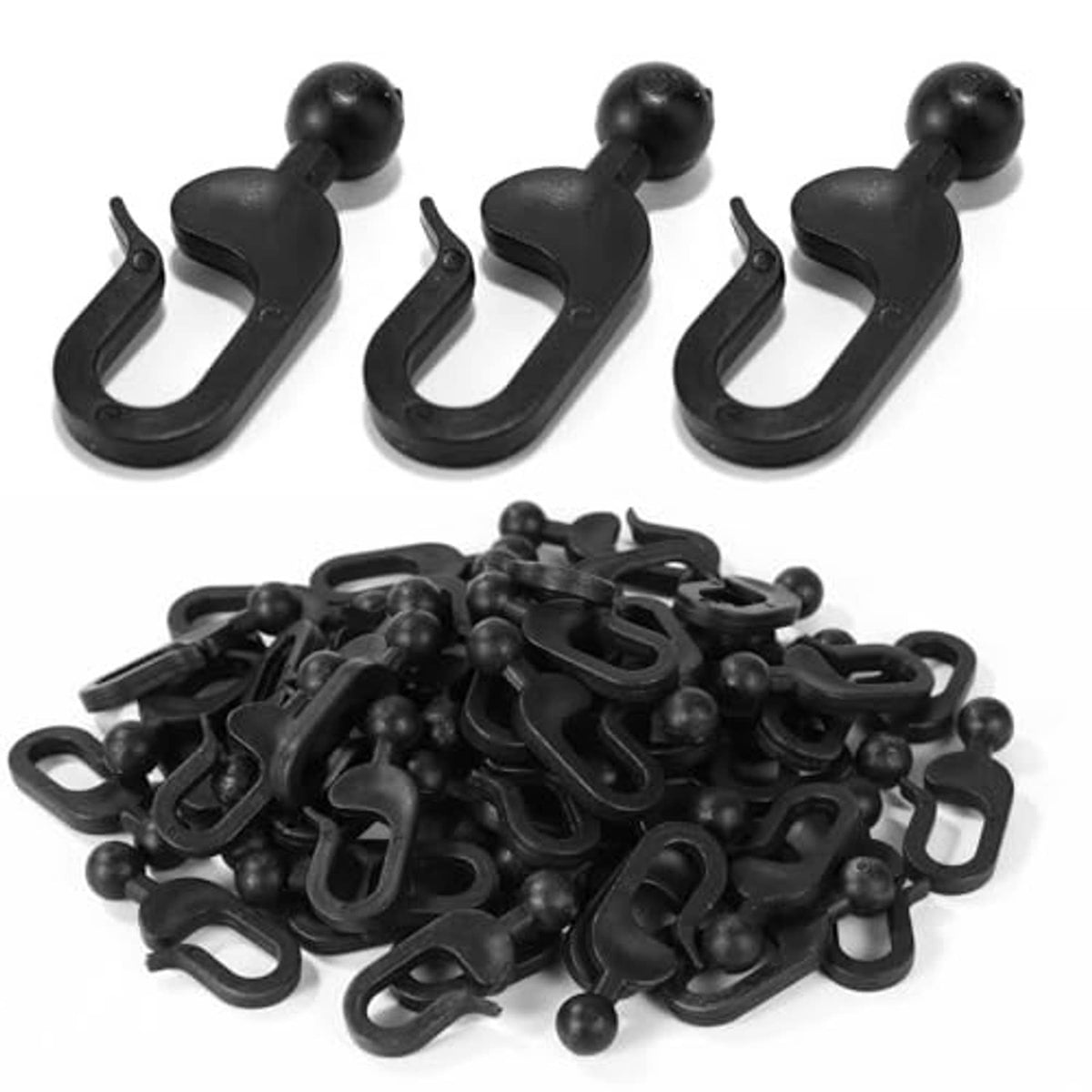 Black plastic curtain track hooks, assorted pieces in a pile