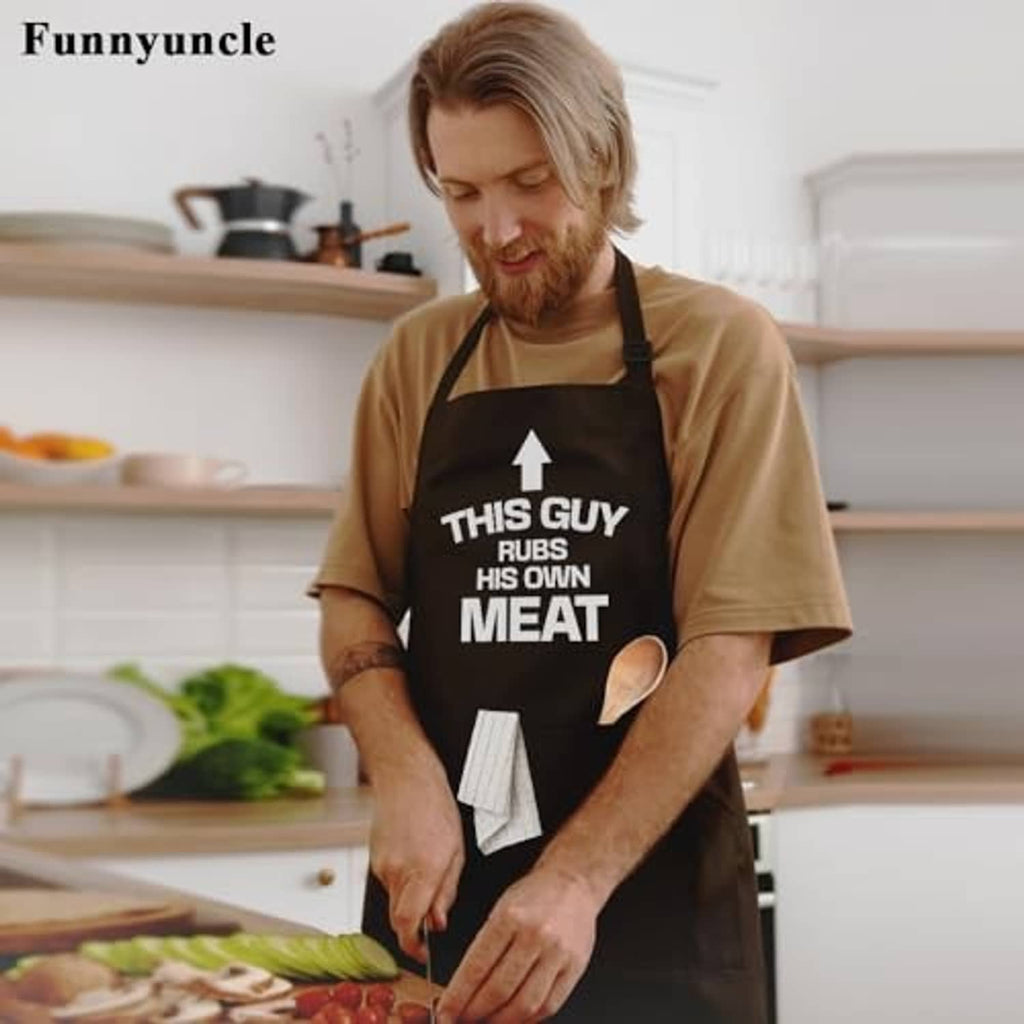 Black grilling apron with 'THIS GUY RUBS HIS OWN MEAT' text and neck strap