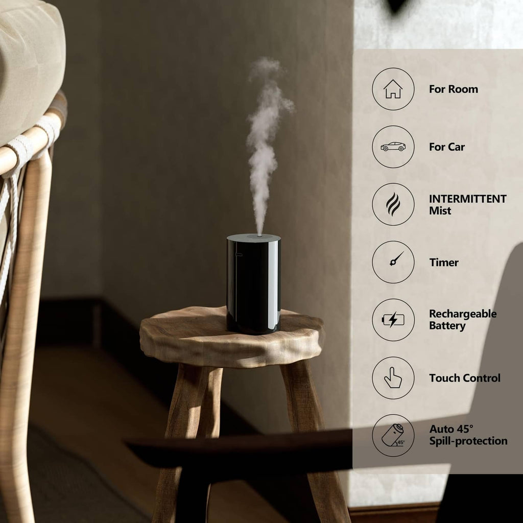 Airversa waterless essential oil diffuser, black cylinder releasing a visible mist plume