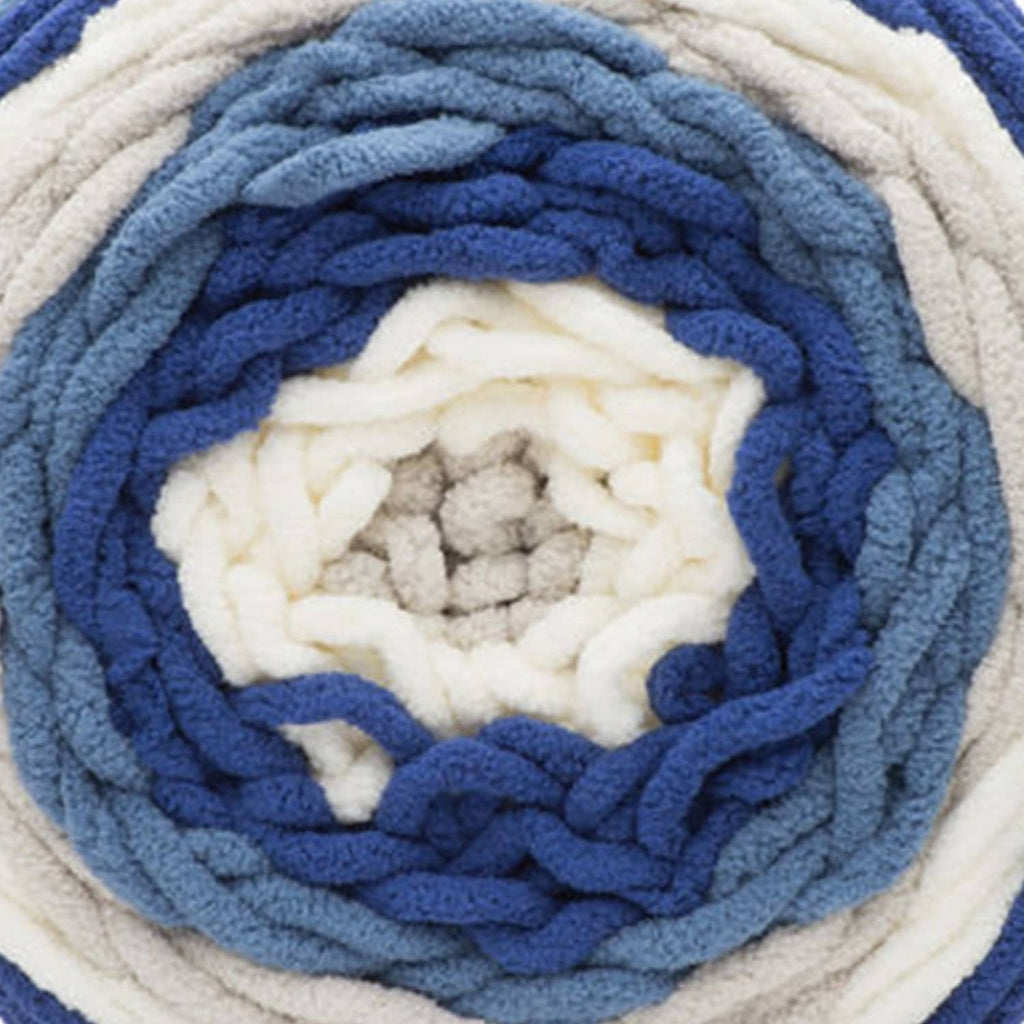 Close-up of blue and cream self-striping yarn ball and textured loops