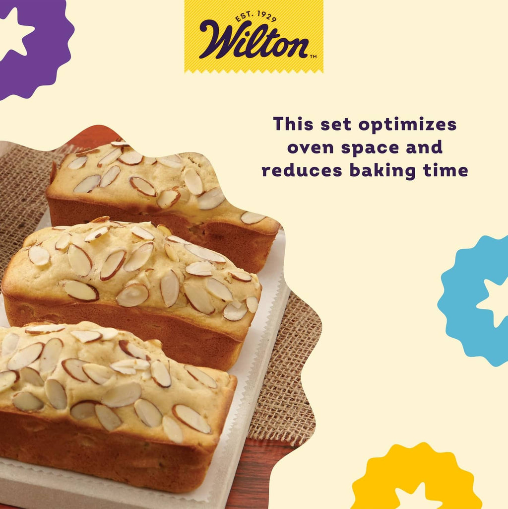 Non-stick mini loaf pans with three baked mini loaves on a parchment-lined tray