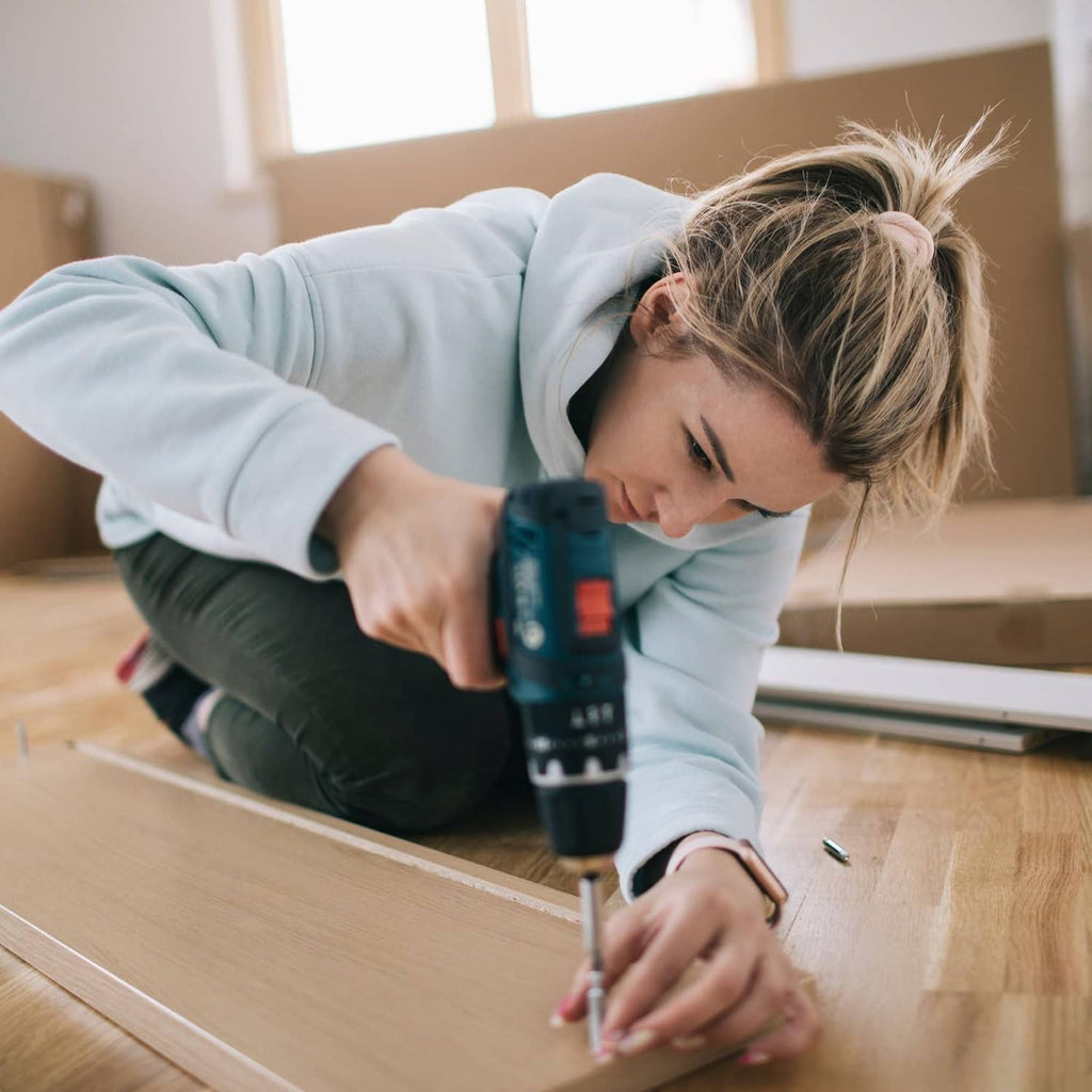 Hex screwdriver bit set being used to drive screws into wood