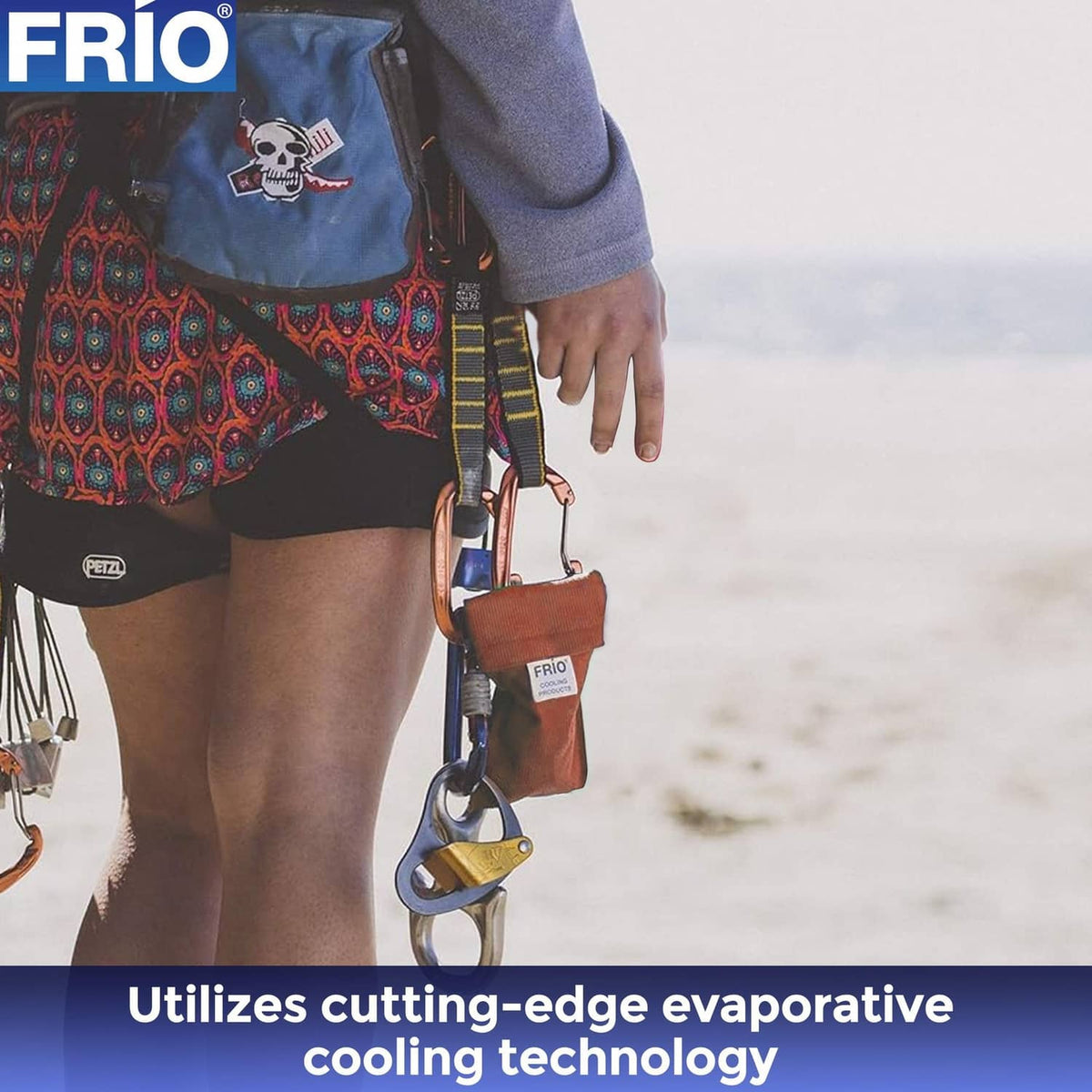 Orange FRIO cooling wallet with label attached to a carabiner