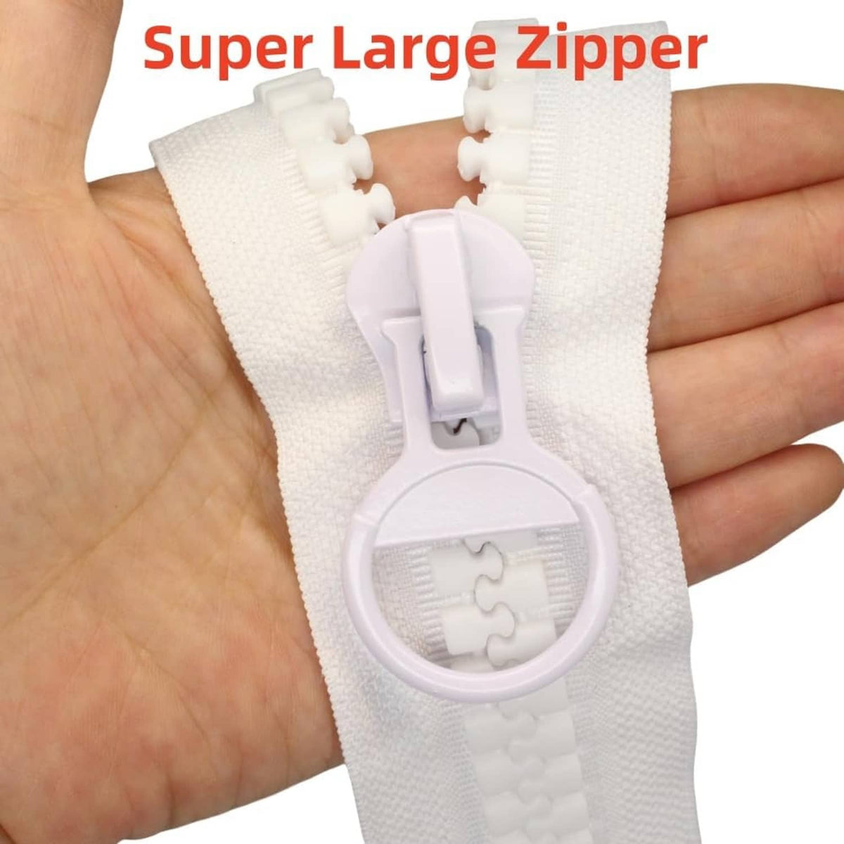 White plastic zipper on backing with large circular slider and pull