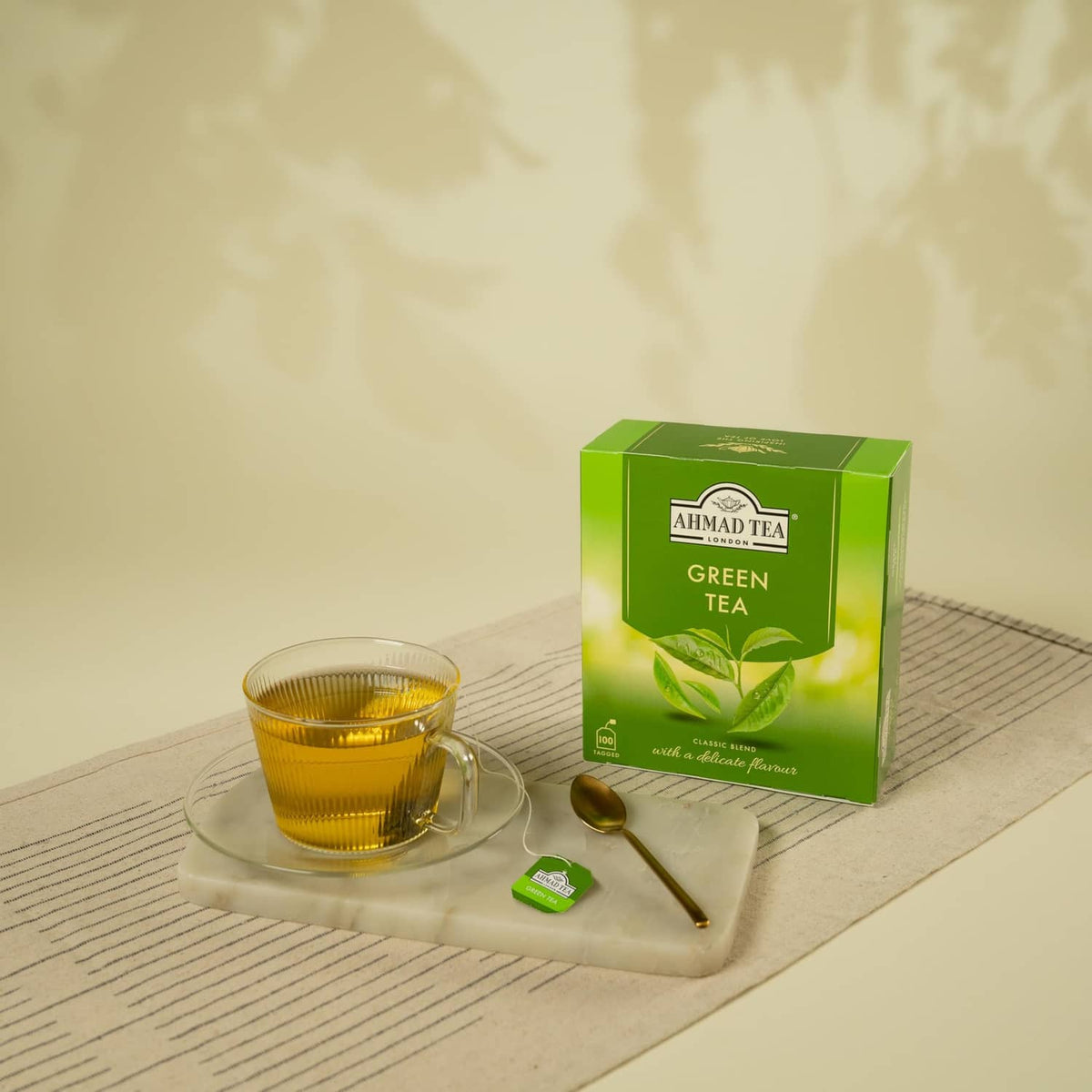 Ahmad Tea Green Tea box with a glass cup and small green tea sachet