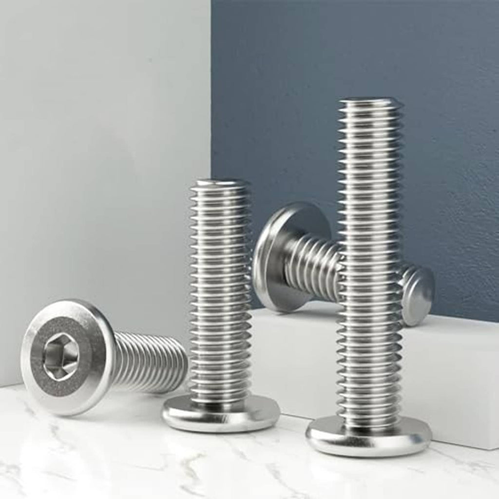 Four stainless steel socket cap screws standing upright, hex socket drive, flat heads