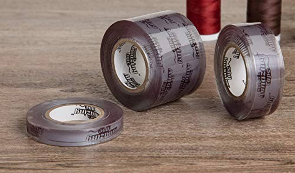 Purple non-adhesive stretch-wrap tape rolls, two upright and one lying down