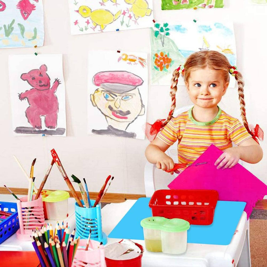 Pink silicone craft mat on a table with art supplies and scissors