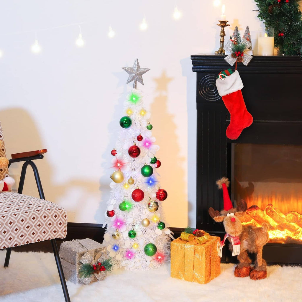 White pop-up Christmas tree with multicolor LED lights, ornaments, and silver star topper