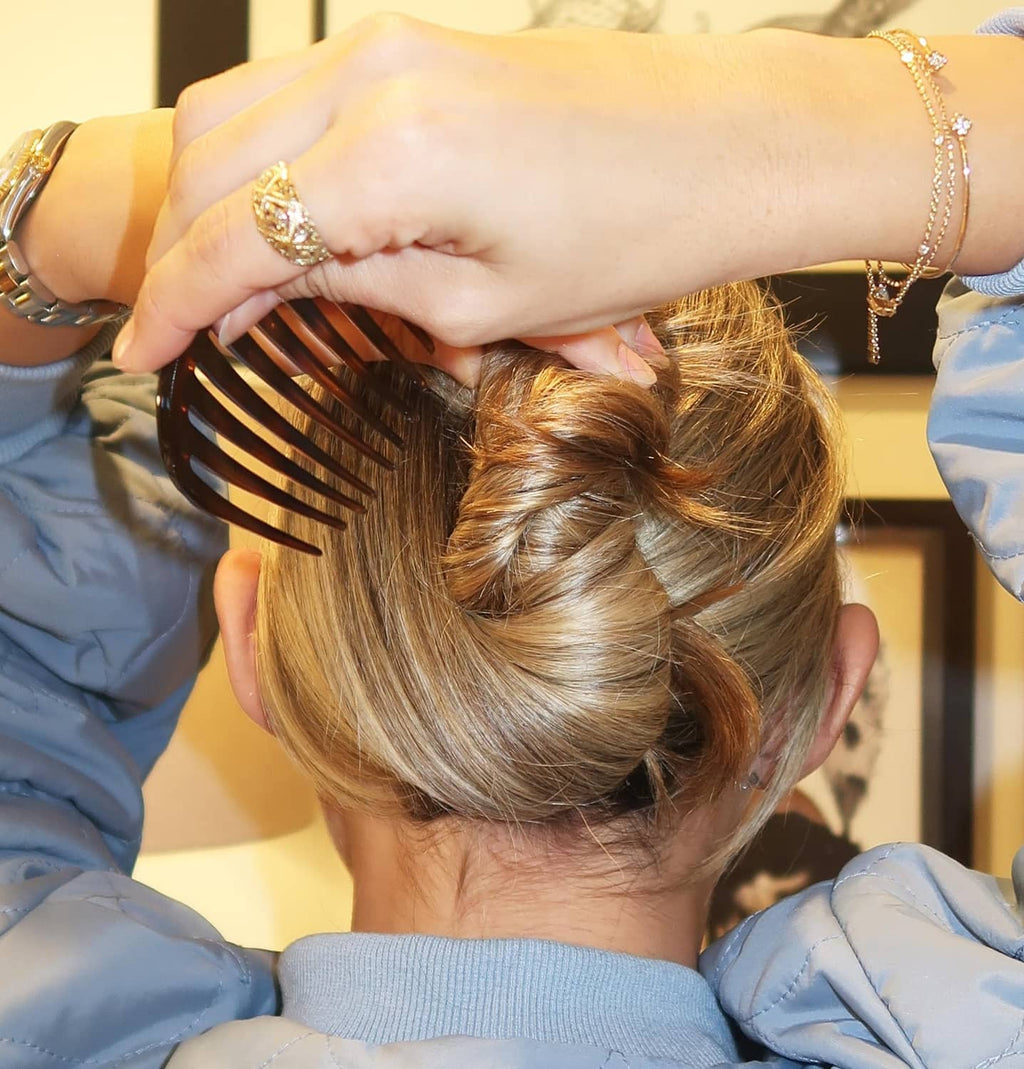 Tortoise shell side comb in use, holding hair in a bun