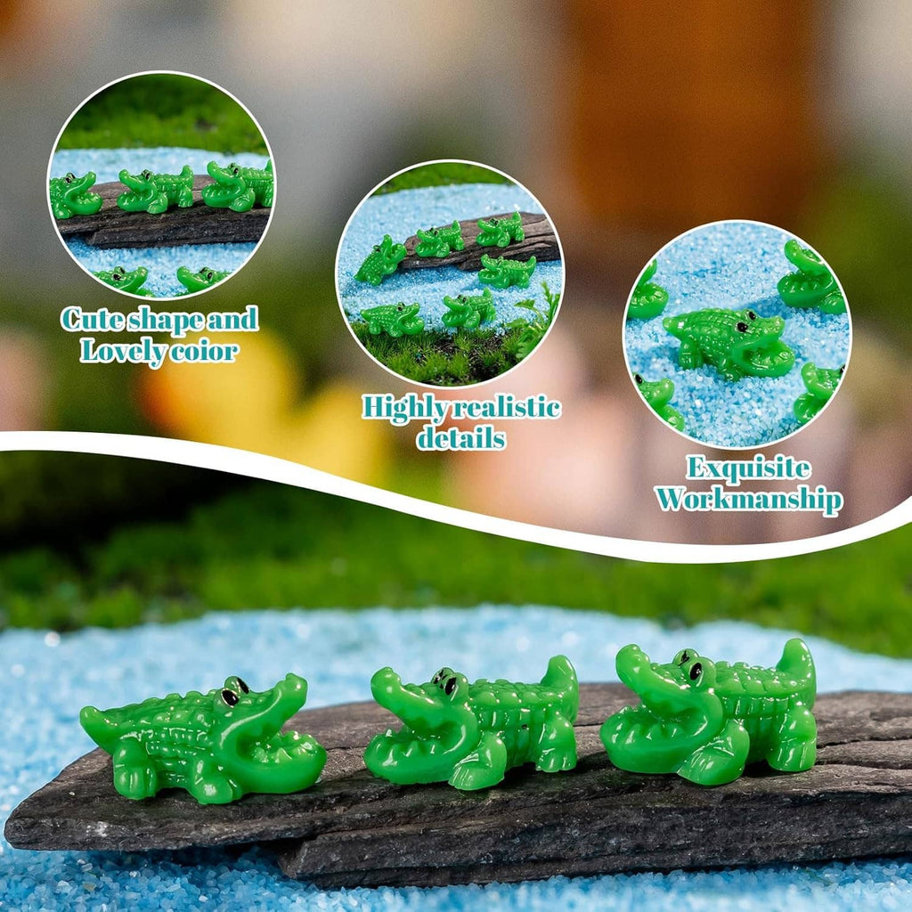 Green mini crocodile resin figurines clustered on a dark rock over blue gravel