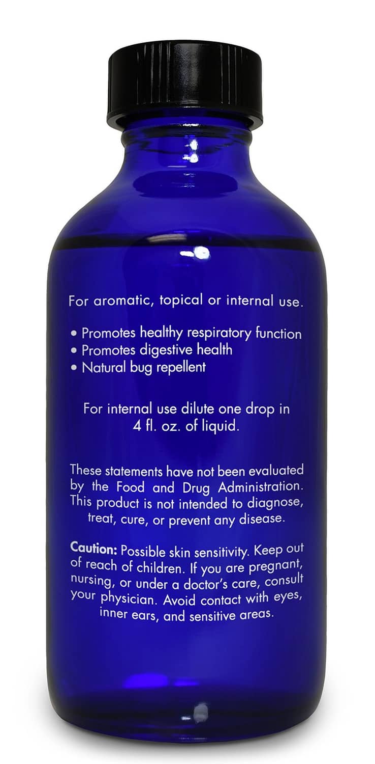 Blue essential oil bottle back label with usage directions and caution text