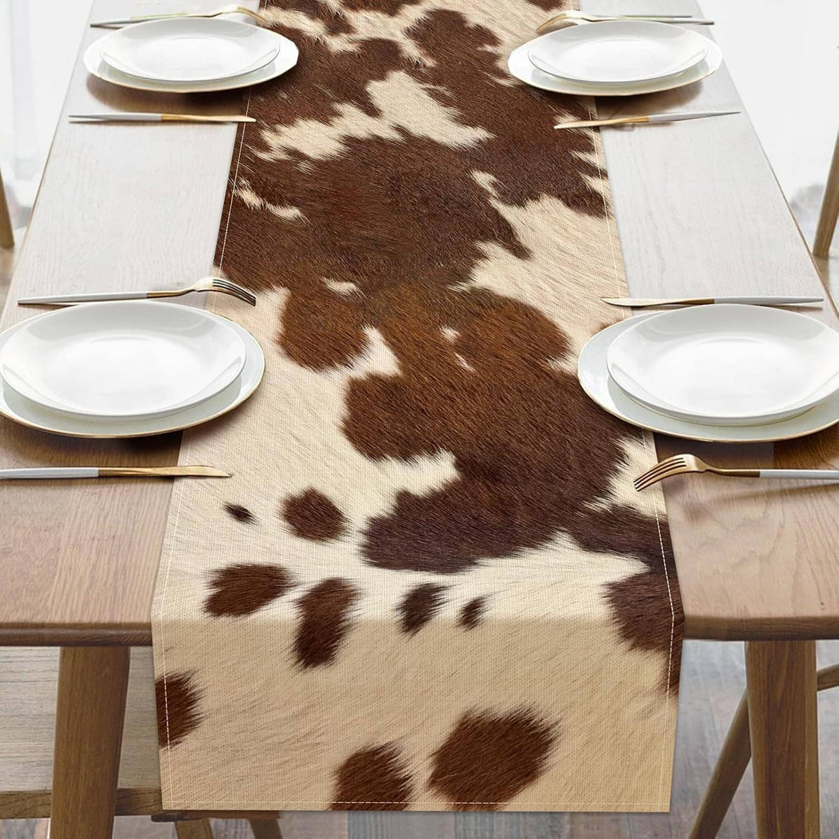 Cow print table runner with brown and white patches and straight stitched edges