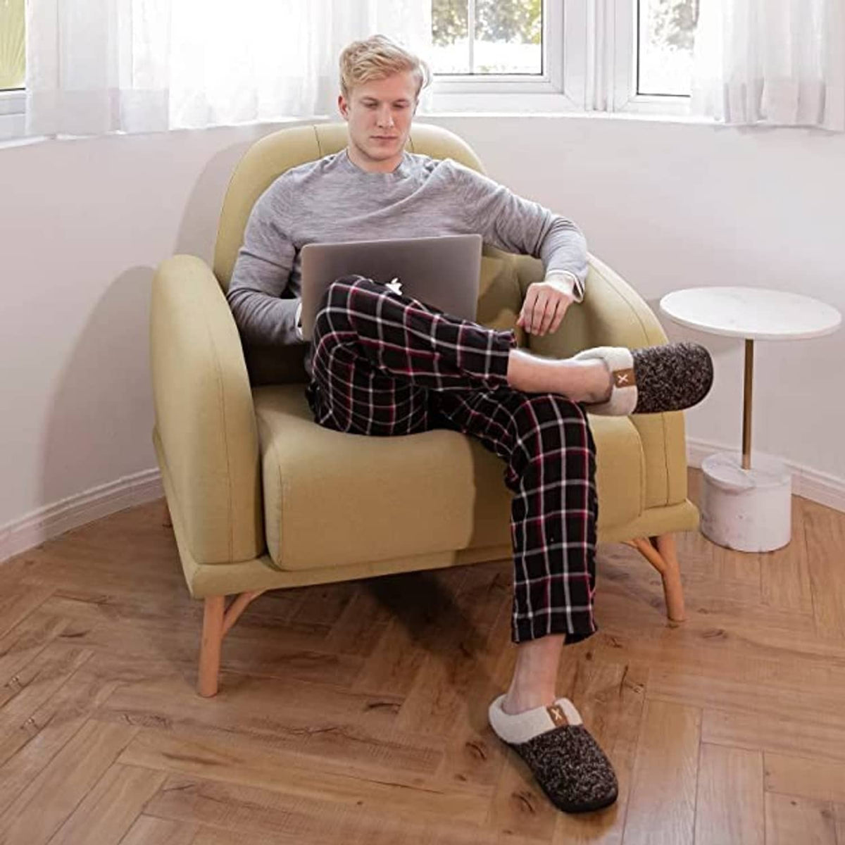 Men wearing sherpa-lined slip-on slippers with dark speckled uppers indoors