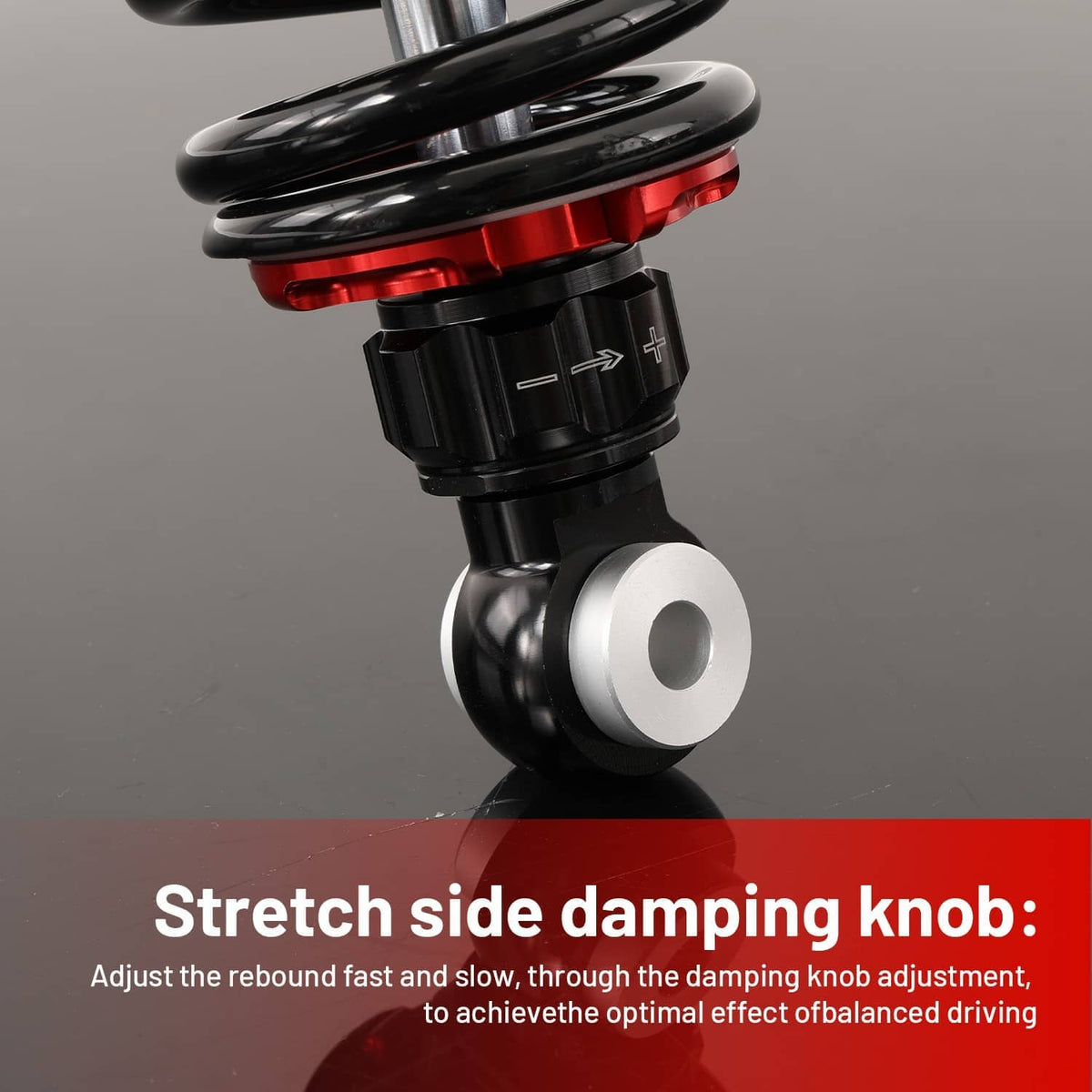 Single shock absorber detail showing red spring seat and black damping knob connection
