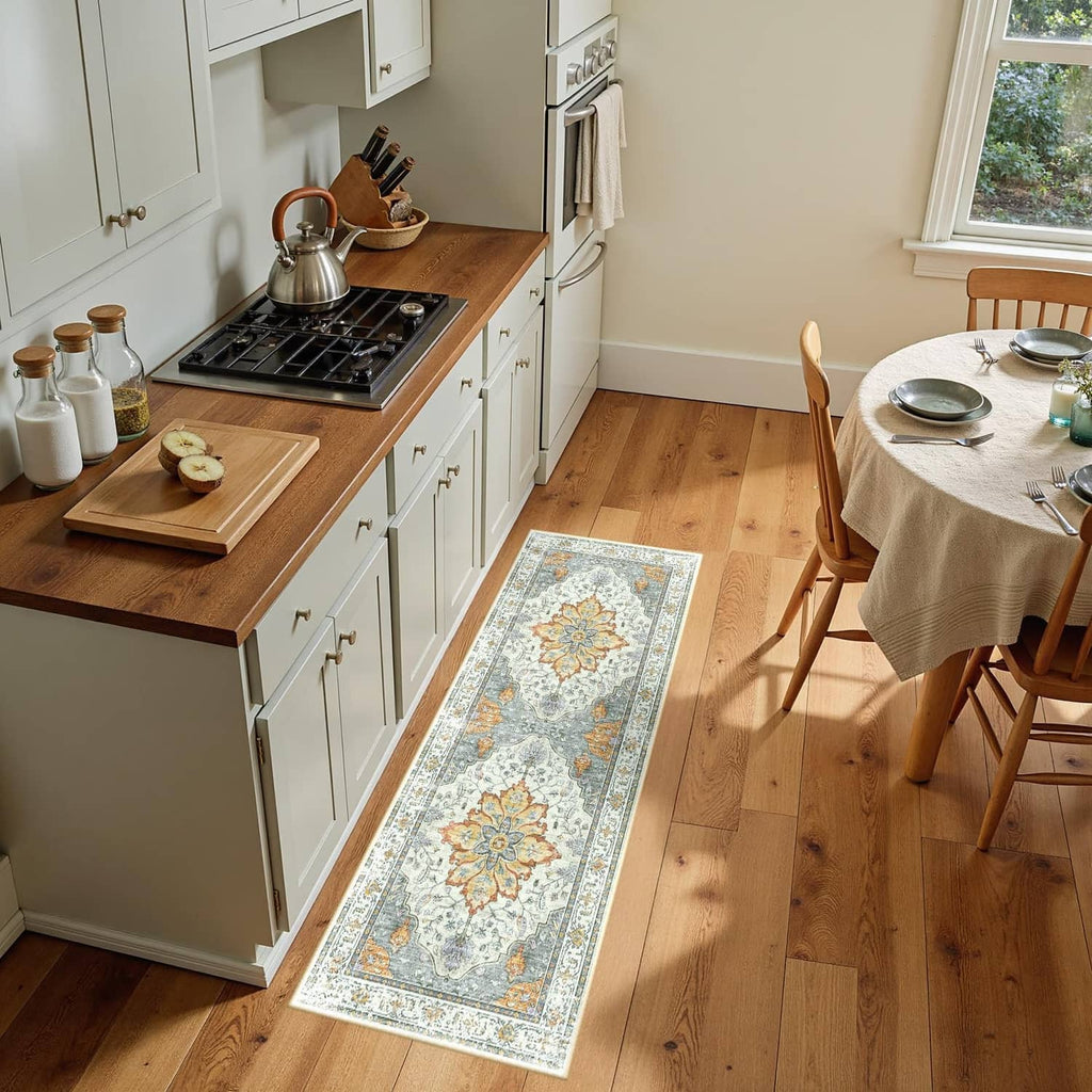 Rectangular washable area rug with light blue, beige, orange floral medallion pattern