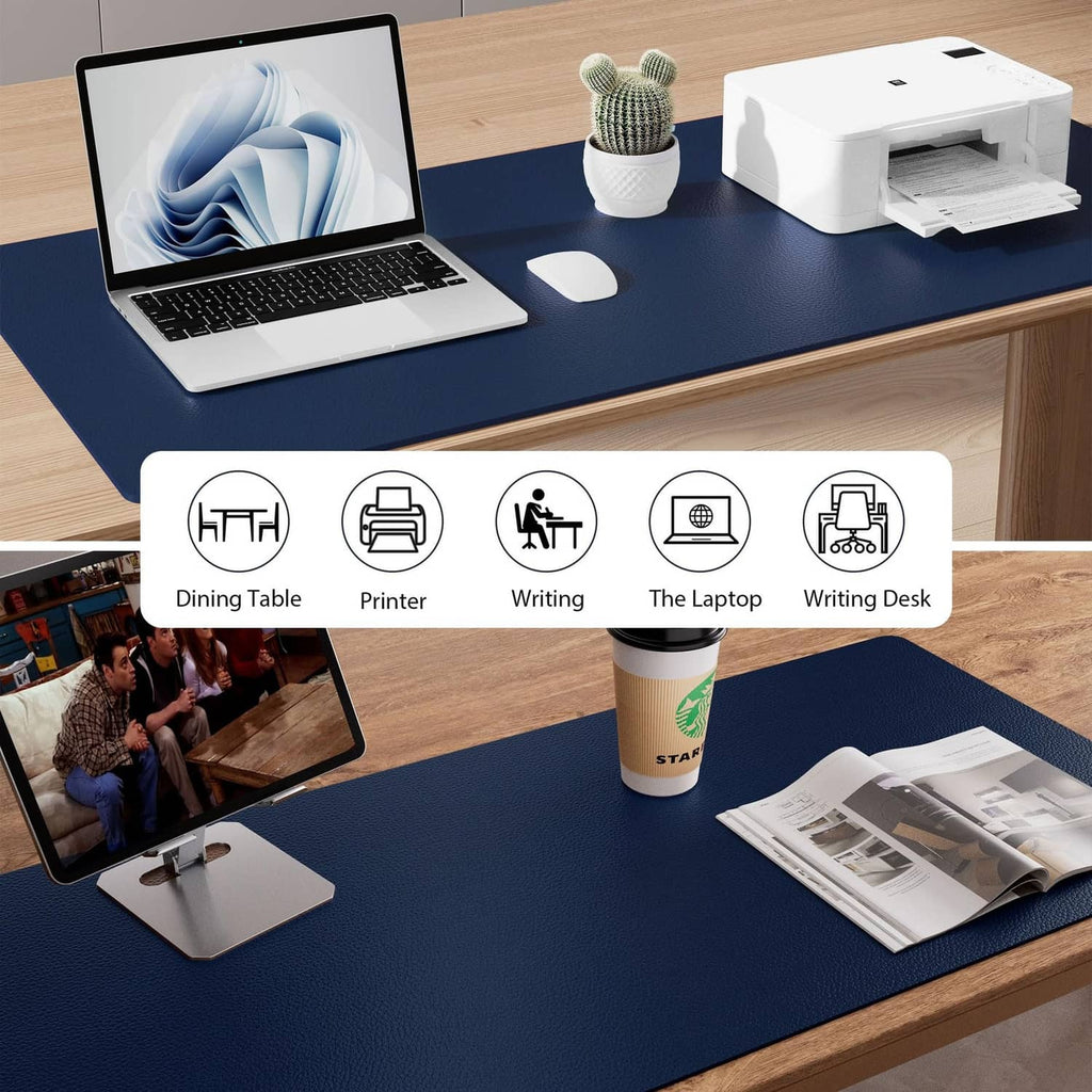 Dark blue desk pad protector on a desk with electronics and office supplies