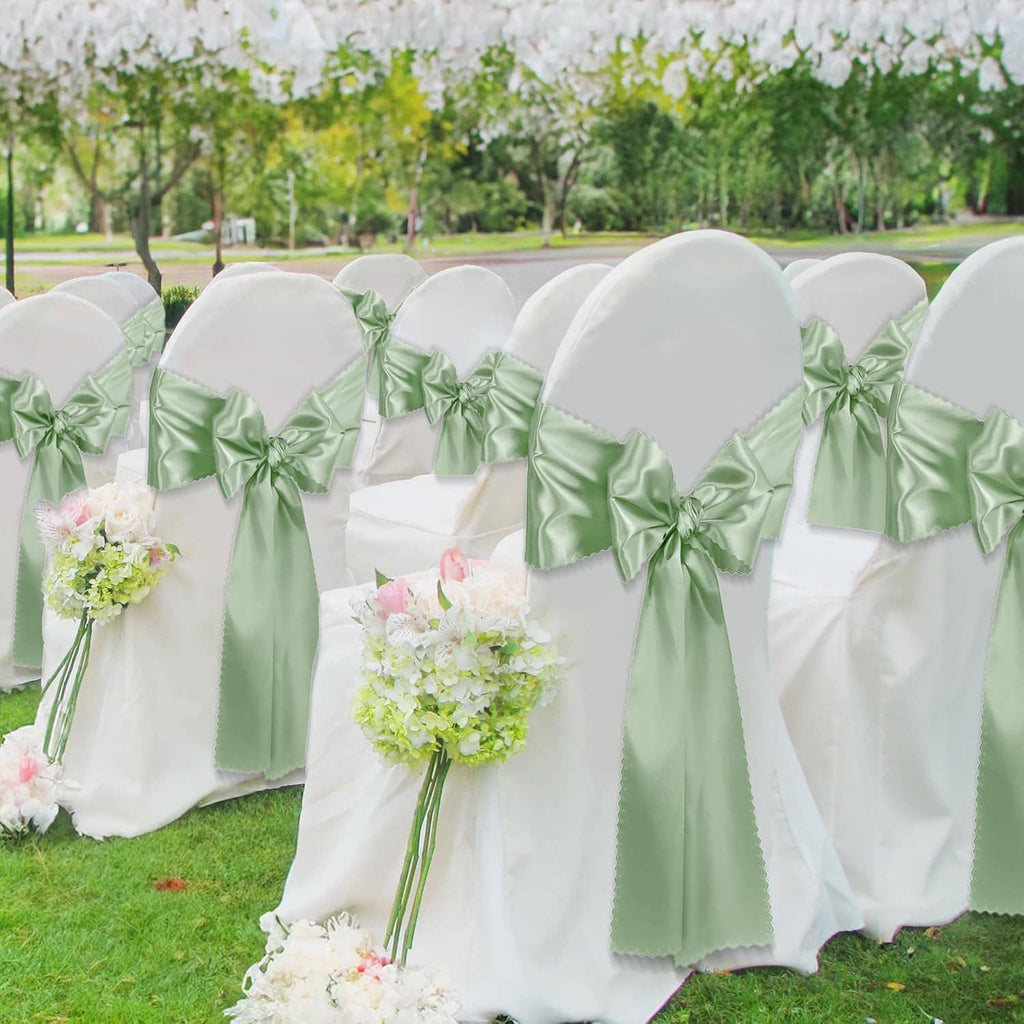 Sage green satin chair cover sashes tied in bows with white chair backs