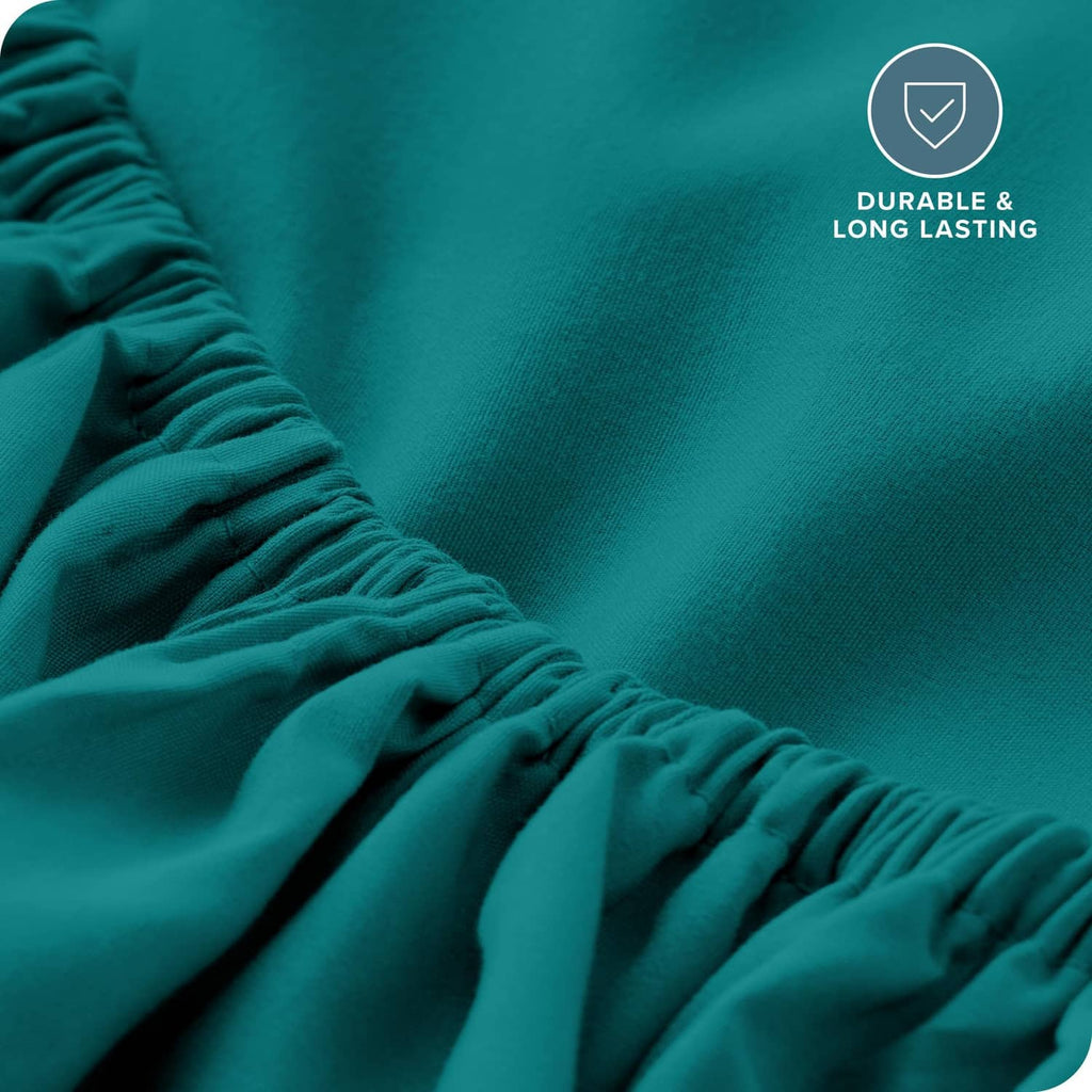 Teal green fitted sheet fabric detail with gathered elastic edge