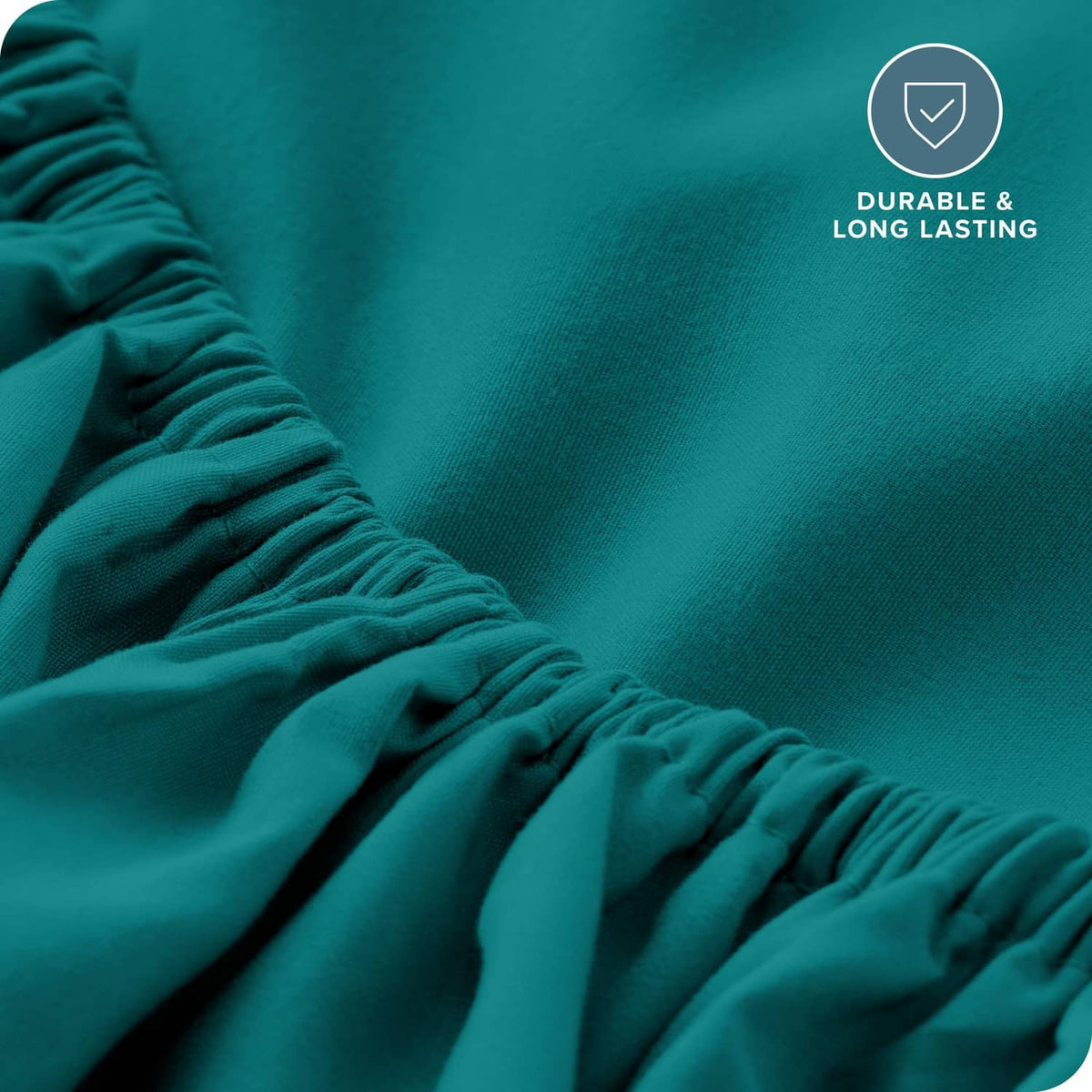 Teal green fitted sheet fabric detail with gathered elastic edge