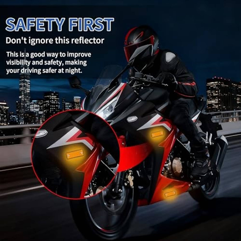 Orange reflector accents on a motorcycle fork and frame, rectangular with screw holes
