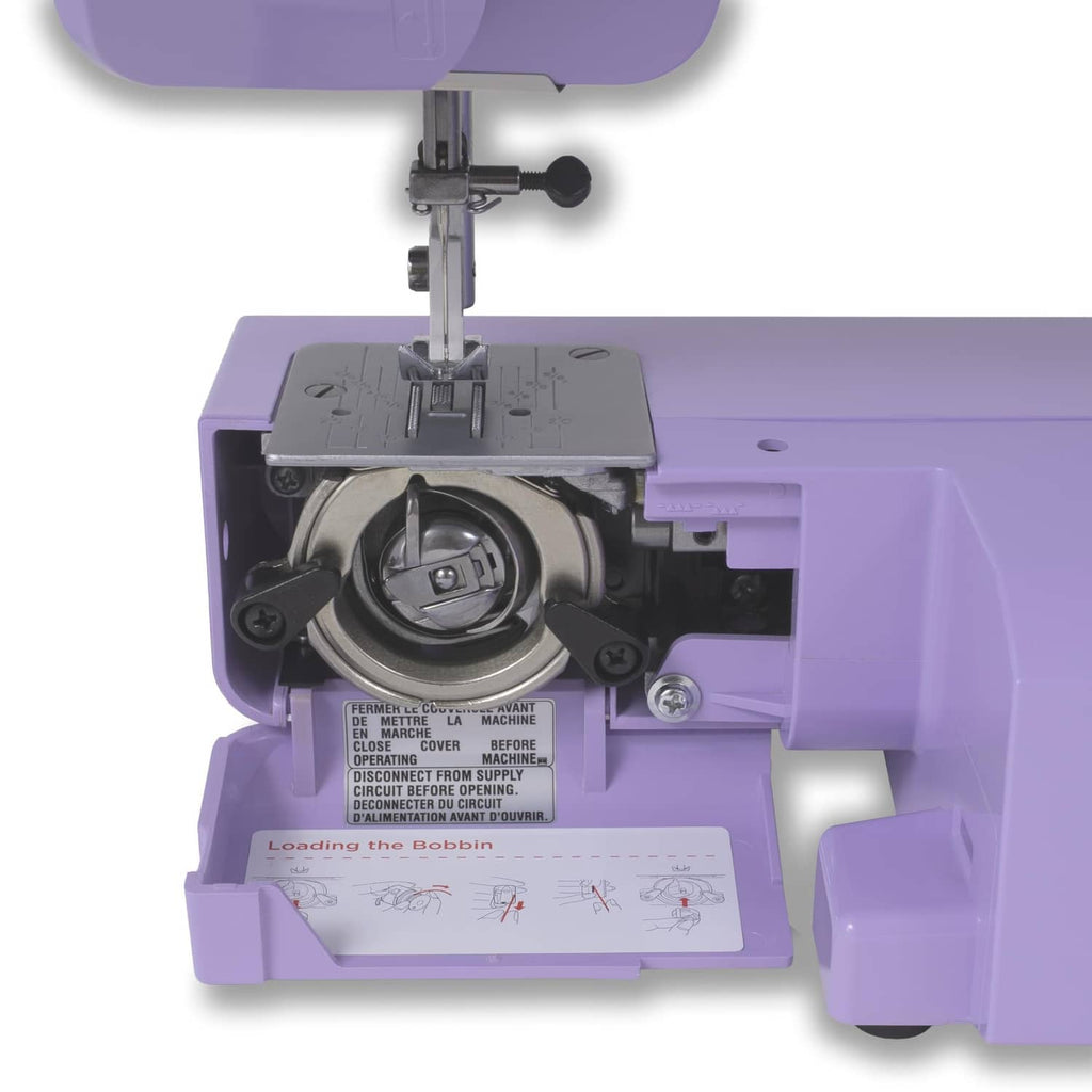 Open bobbin compartment and needle mechanism on a purple Janome sewing machine