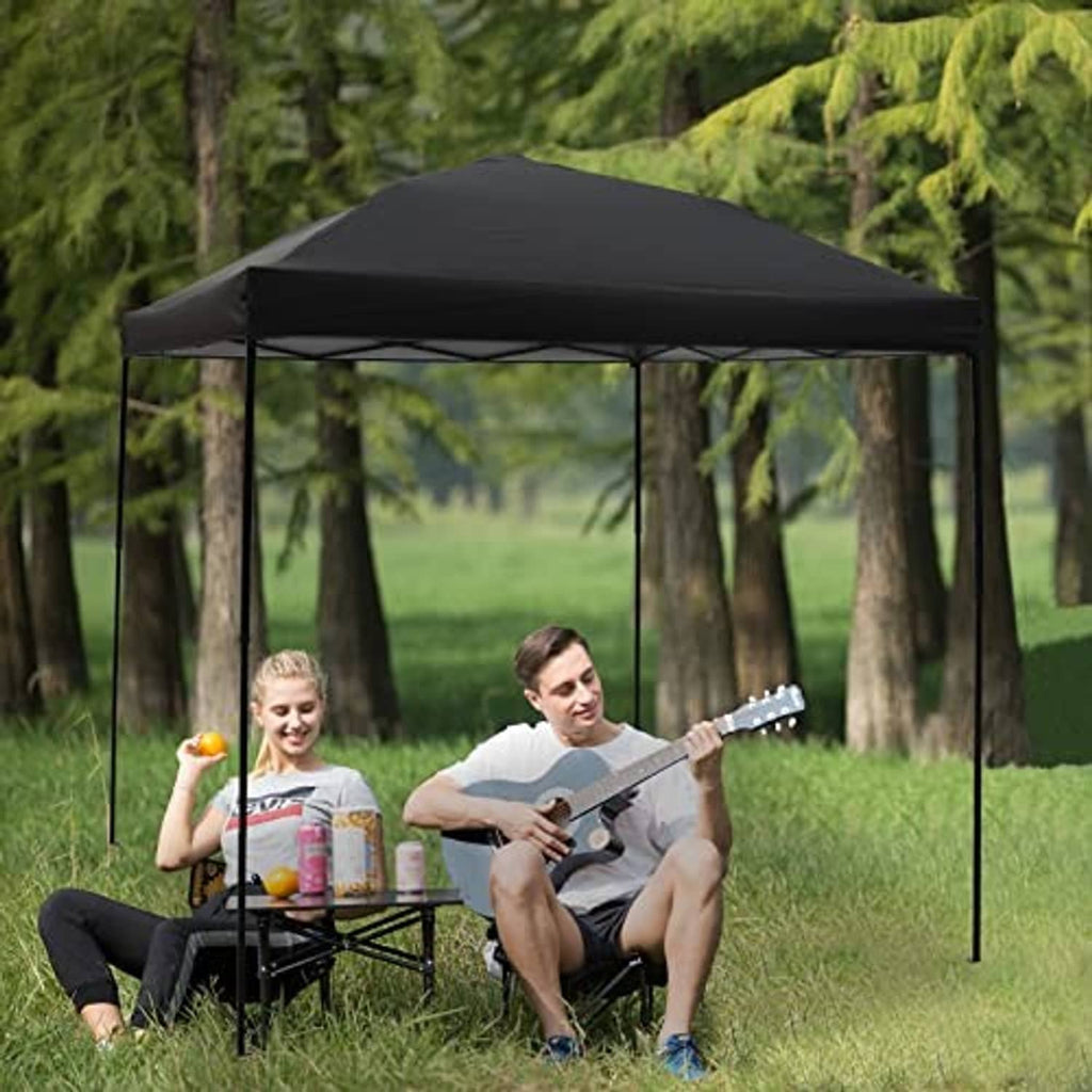 Black pop-up canopy top over outdoor table, four corner legs