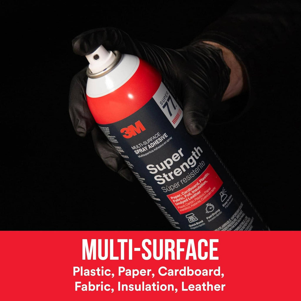Super Strength spray adhesive can in a gloved hand with black nozzle