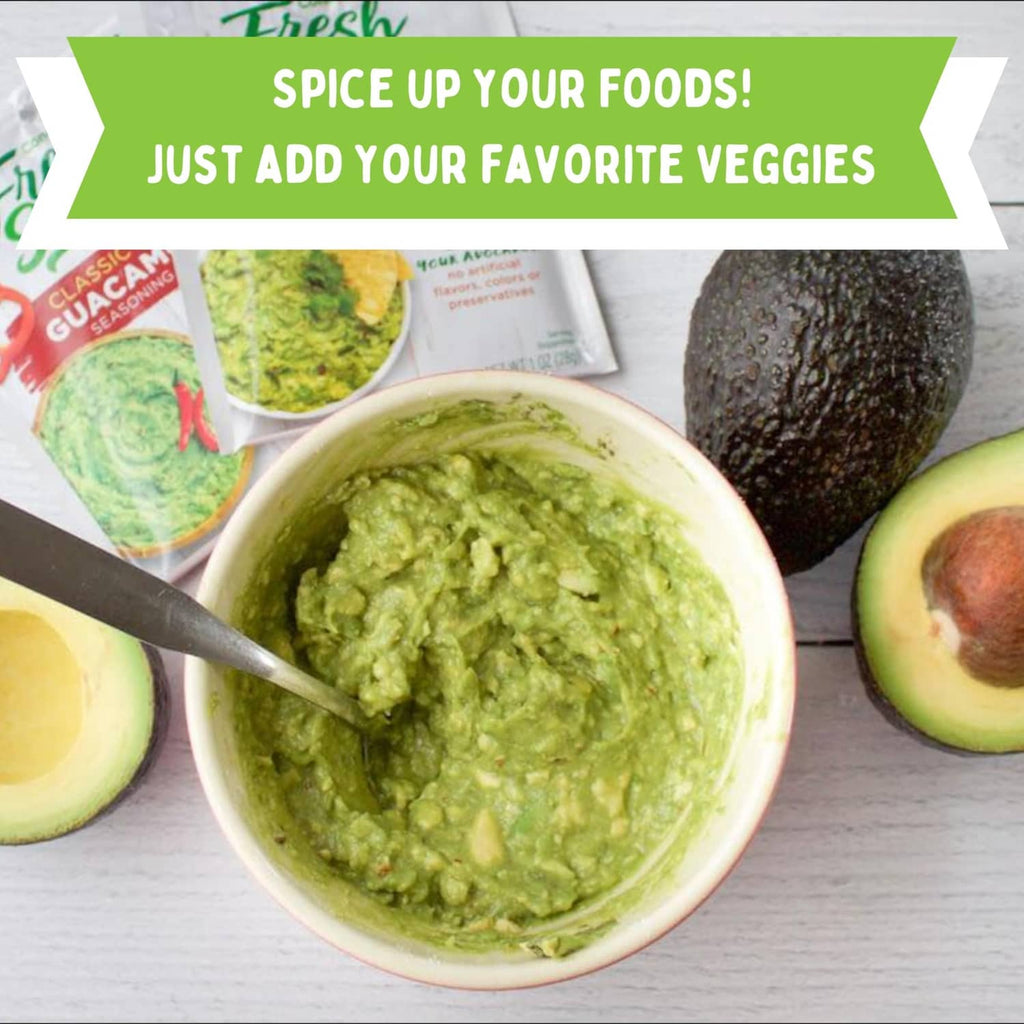 Green salsa in a bowl with spoon, avocado slices, and lime halves