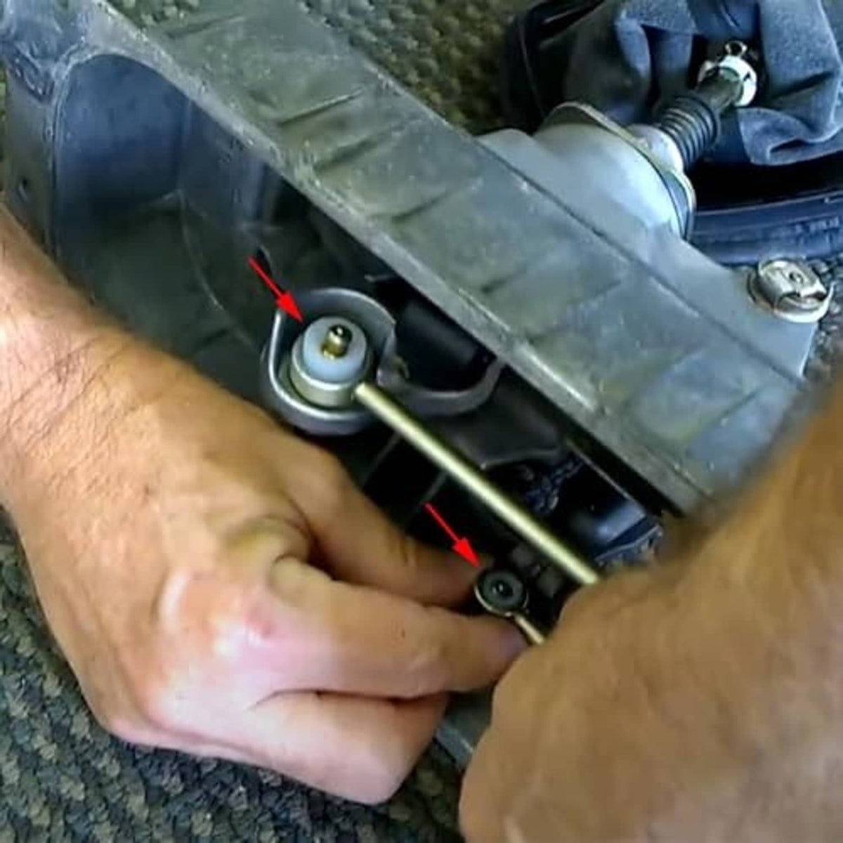 Installed shift cable bushing area with black bushing and metal link rod