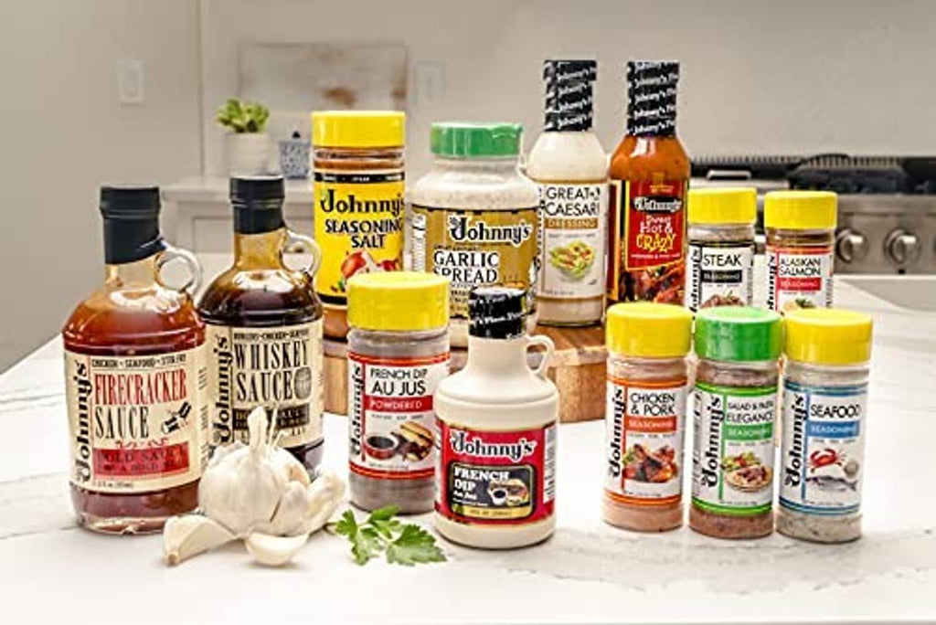 Assorted Johnny's seasoning bottles and garlic spread jars with various colored caps