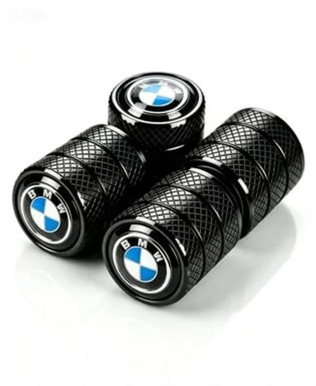Four black tire valve stem caps with textured pattern and BMW blue-and-white logos